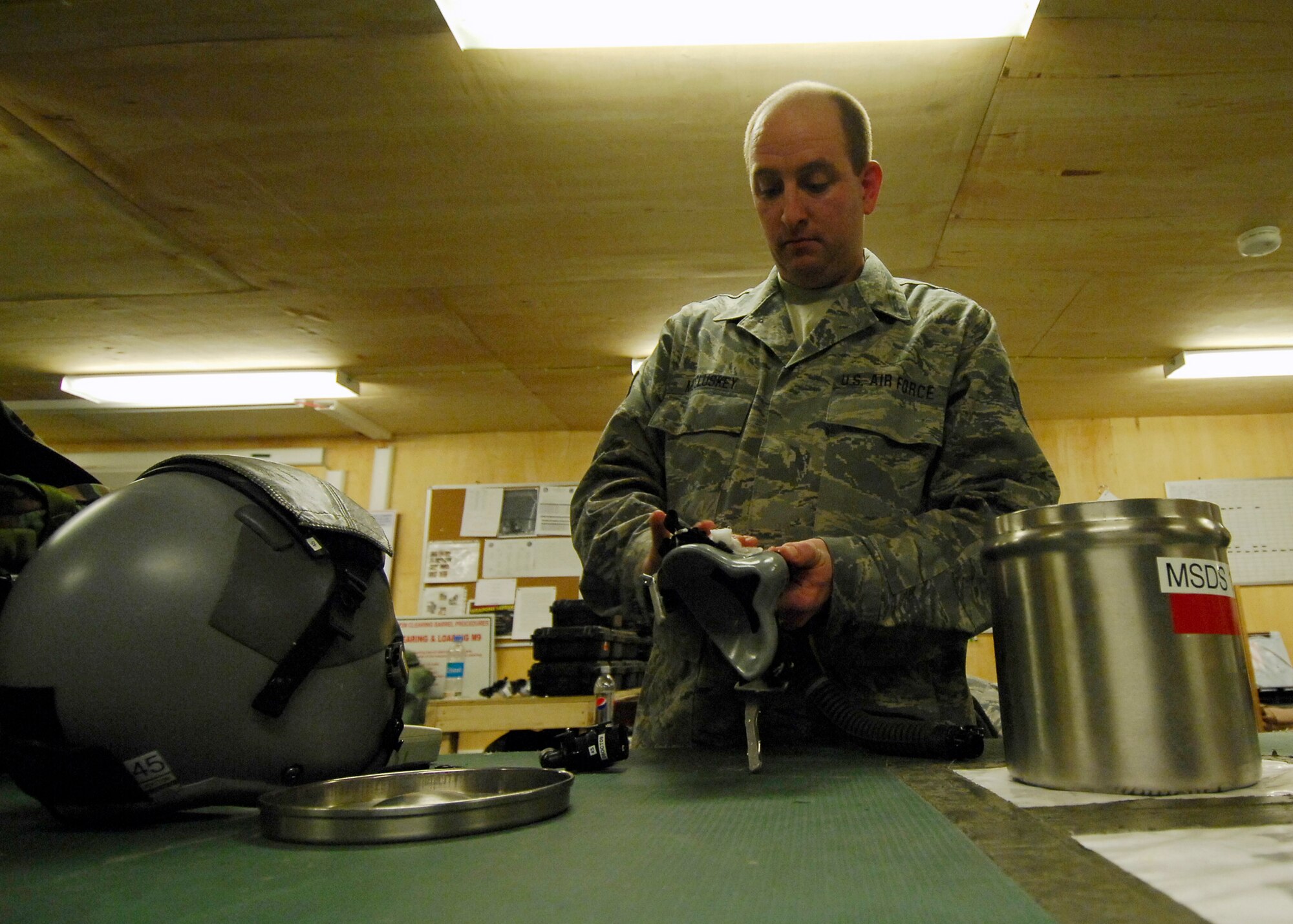 BAGRAM AIRFIELD, Afghanistan -- Technical Sgt. William McCluskey, an aircrew flight equipment Airman from the 774th Expeditionary Airlift Squadron, sanitizes and assures the breathing mask has no damages here, Oct. 4, 2009.  Sergeant McCluskey, a Mineral Wells, Texas native, is deployed from the Texas Air National Guard's 136th Airlift Wing.  (U.S. Air Force photo/Senior Airman Felicia Juenke)