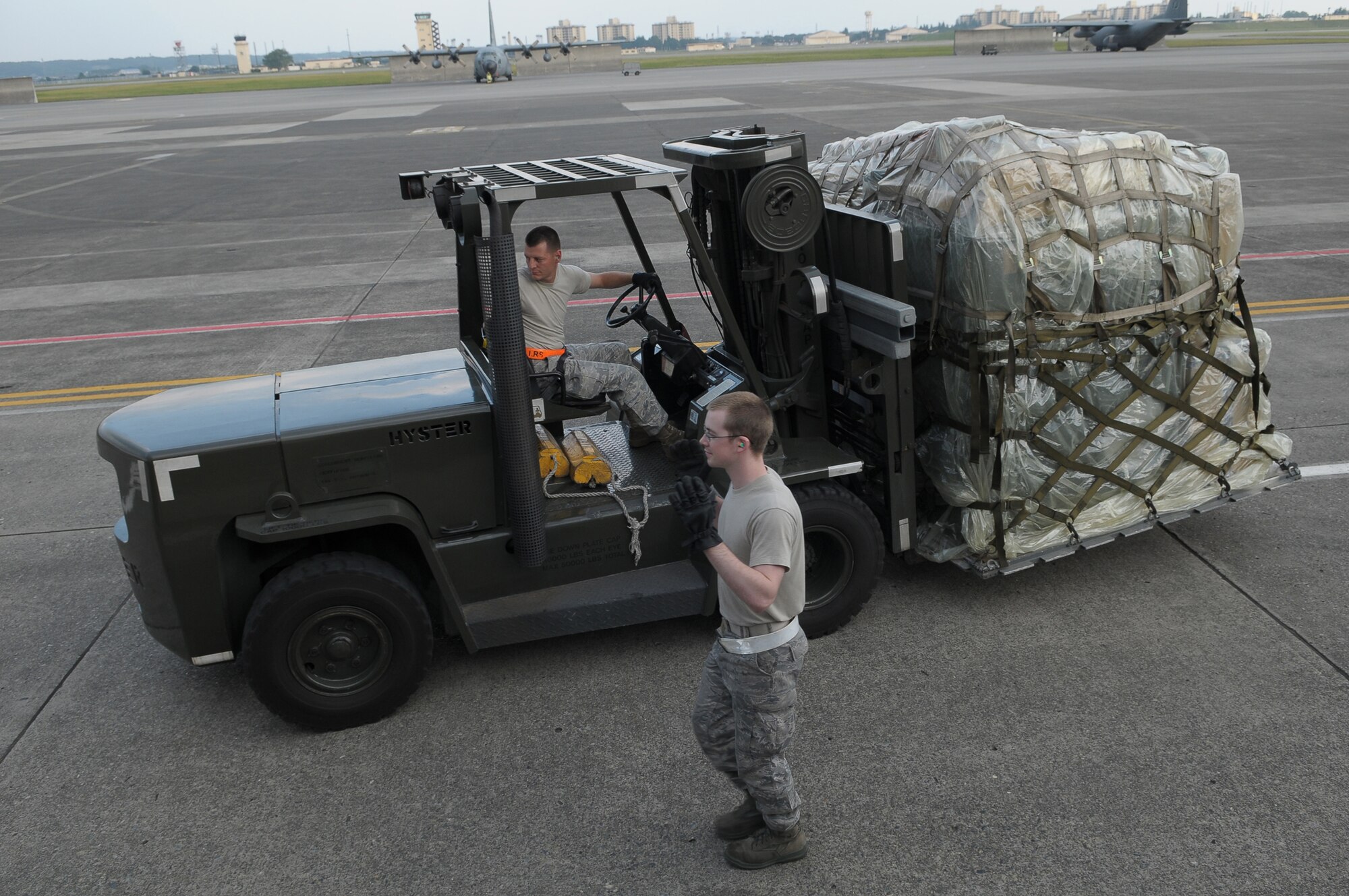 YOKOTA AIR BASE, Japan -- Airman 1st Class James Kliever, 374th Maintenance Squadron, spots Staff Sgt. Jonathon Fleck, 374th MXS, as they move a pallet of medical supplies Oct. 4 to support the deployment of a U.S. Air Force Humanitarian Assistance Rapid Response Team to Padang, Indonesia. Medical personnel here built nine pallets totaling more than 35,000 pounds of equipment. The HARRT, which includes members from here and Andersen Air Force Base, Guam, is scheduled to depart Oct. 5 aboard a C-17 Globemaster III. (U.S. Air Force photo/Airman 1st Class Sean Martin)

