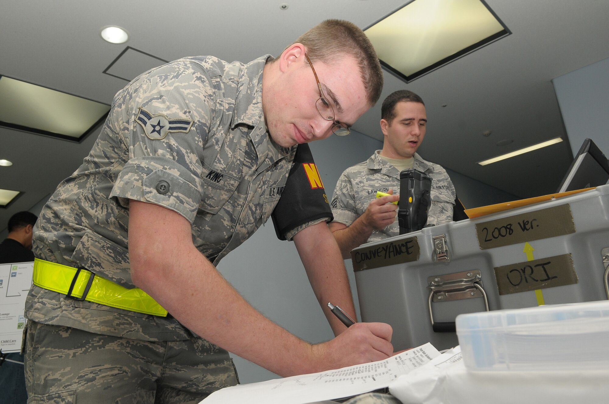 YOKOTA AIR BASE, Japan -- Airman 1st Class Chris King, 374th Air Mobility Squadron, looks over a passenger manifest Oct 4 as part of a noncombatant evacuation operations exercise. The exercise tested Yokota's noncombatant reception control center's ability to account for and process the noncombatants. (U.S. Air Force photo/Airman 1st Class Sean Martin) 