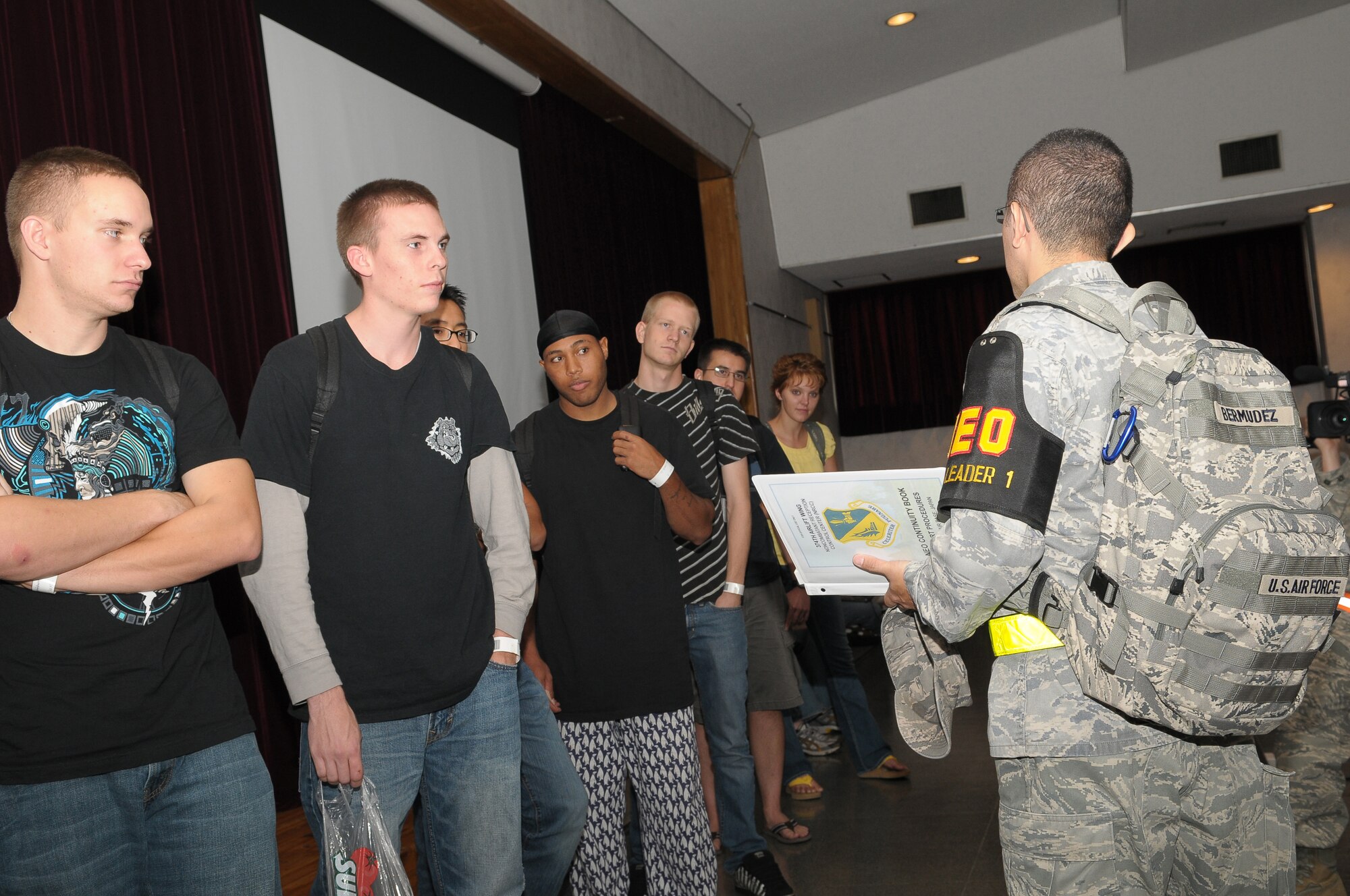 YOKOTA AIR BASE, Japan -- Technical Sgt. Jeimmy Bermudez, 374th Force Support Squadron, pre-briefs roll players Oct 4 as part of a noncombatant evacuation operations exercise. The exercise tested Yokota's noncombatant reception control center's ability to account for and process the noncombatants. (U.S. Air Force photo/Airman 1st Class Sean Martin)