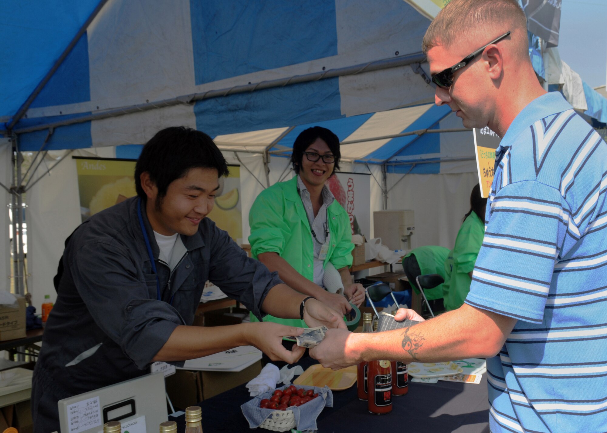 Staff Sgt. James Bierman, from the 18th Equipment Maintenance Squadron at Kadena Air Base, Japan, buys some locally-made tomato juice at a local farm festival during the visit to Hyakuri Air Base, Japan, Oct. 04. The squadron is participating in an Aviation Training Relocation exercise between the U.S. Air Force and the Japan Air Self Defense Force from Oct. 5-9, 2009.