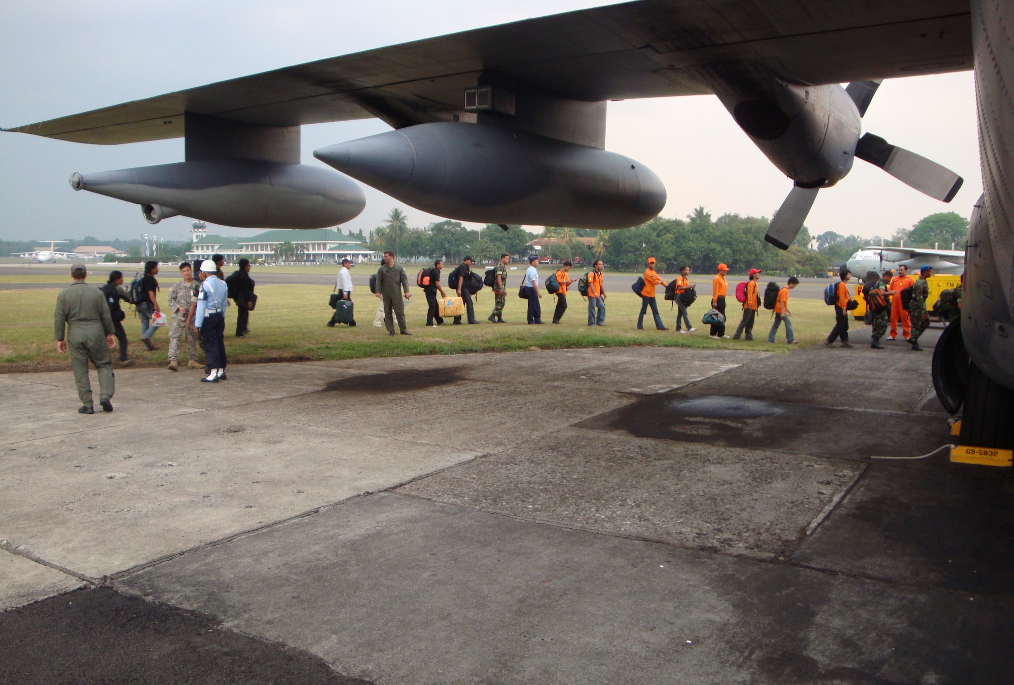 BANDUNG, Indonesia -- Members of the 353rd Special Operations Group, Indonesian Air Force Korpaskhas, a special operations branch of the Indonesian Air Force, and emergency response teams board a MC-130P Combat Shadow here Oct. 2. Members of group and Korpaskhas immediately started moving emergency response teams, equipment and relief supplies to the Padang area to support humanitarian relief operations after a 7.6 magnitude earthquake and a slightly smaller one struck the area Sept. 30 and Oct. 1. (Courtesy photo)                               