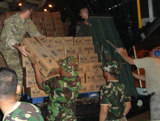 PADANG, Indonesia -- Members of the 353rd Special Operations Group and Indonesian Air Force Korpaskhas, a special operations branch of the Indonesian Air Force, unload relief supplies from a MC-130P Combat Shadow here Oct. 2. Members of group and Korpaskhas immediately started moving emergency response teams, equipment and relief supplies to the Padang area to support humanitarian relief operations after a 7.6 magnitude earthquake and a slightly smaller one struck the area Sept. 30 and Oct. 1. (Courtesy photo)                               