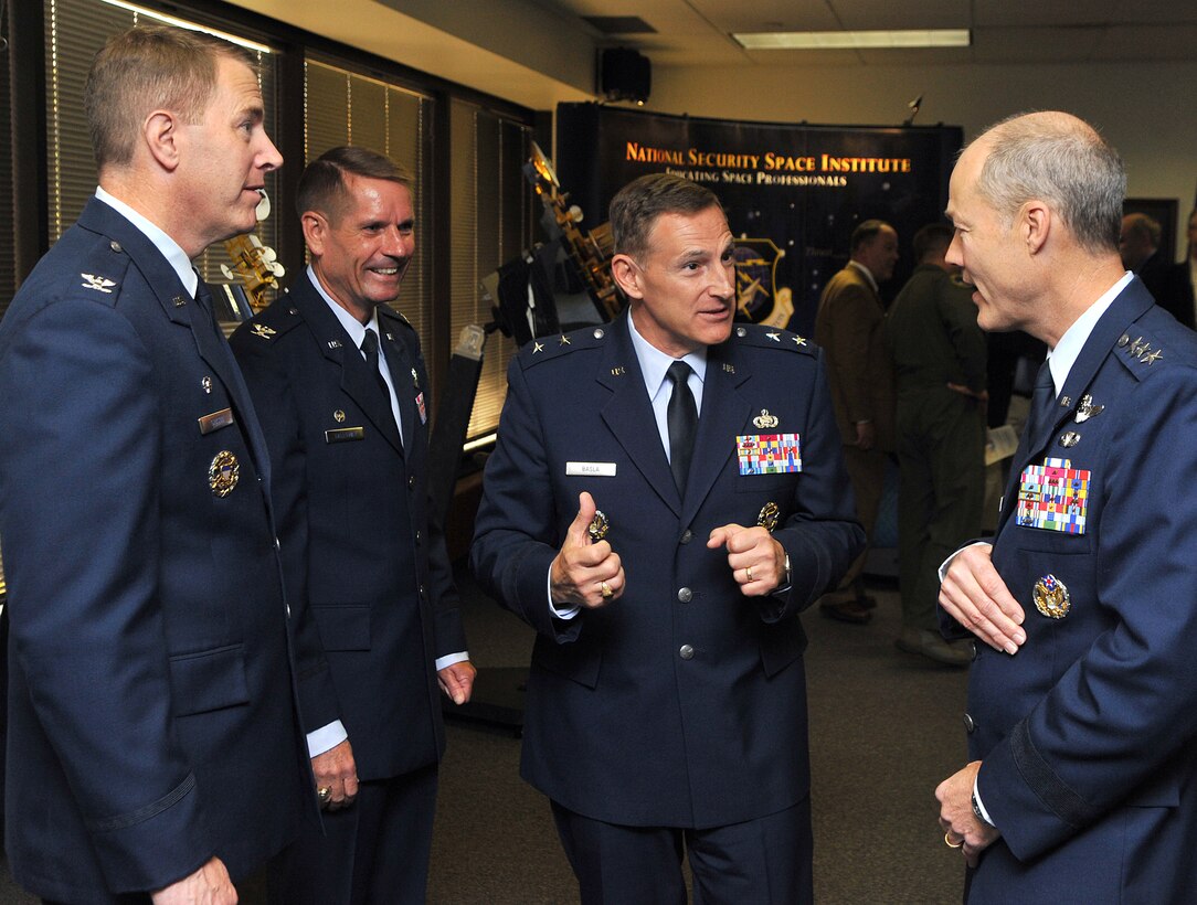 (R to L) Lt. Gen. Allen B. Peck, commander, Air University, Maxwell Air Force Base, Ala., Maj. Gen. Michael J. Basla, vice commander, Air Force Space Command, Peterson Air Force Base, Colo., Col. James P. Galloway III, commander, Ira C. Eaker Center for Professional Development, Maxwell-Gunter Air Force Base, Ala. and Col. Robert D. Gibson, commandant, National Security Space Institute, Peterson Air Force Base, Colo., talk following the reassignment ceremony at the NSSI. Oct. 1, 2009.  (U.S. Air Force Photo By Duncan Wood)