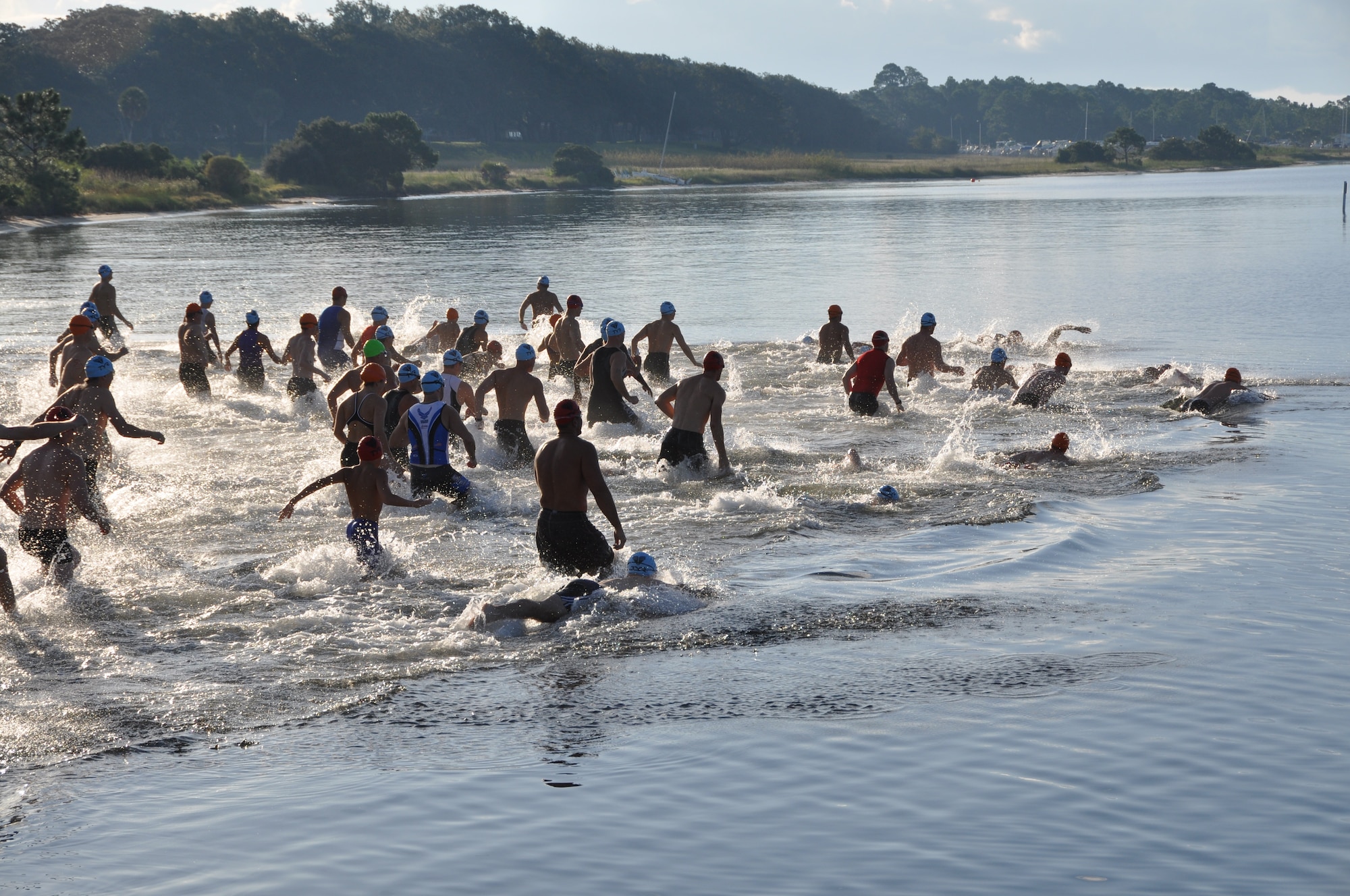 The participants in the Tynman Tri/Duathlon begin the race with a one-third mile swim Oct. 5 at the pier in base housing here.  (U.S. Air Force photo/Airman 1st Class Veronica McMahon)