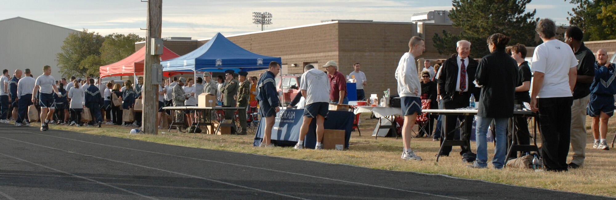 CANNON AIR FORCE BASE, N.M.--  Tents line the side of the track hosting the Oct. 5 commando run where all 27th Special Operatations Wing form up to celebrate the kick-off of the Combined Federal Campaign.  Along-side the main CFC tents were organizations including; Healing the children, Gospel for Asia, Alzheimer's association, Sickle Cell Coallition, Community Health Charity, Catholic Charity and C.A.I.R. Tutoring.  (U.S. Air Force photo by Airman 1st Class James Bell)