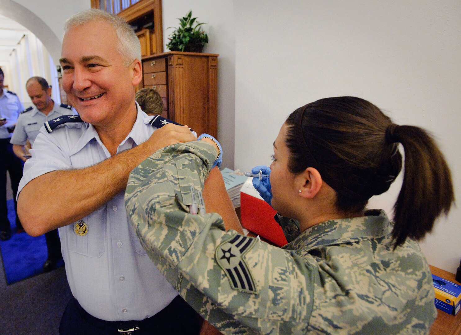 Maj. Gen. Erv Lessel, AETC Director of Plans, Requirements, Programs and Analysis receives his annual flu shot from Senior Airman April DeLuna of the 12th Medical Group at Randolph Air Force Base, Texas. (U.S. Air Force photo/Steve Thurow)