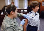 Senior Airman April DeLuna of the 12th Medical Group at Randolph Air Force Base, Texas gives Col. Merrily Madero, AETC Director of Staff her annual flu shot. (U.S. Air Force photo/Steve Thurow)