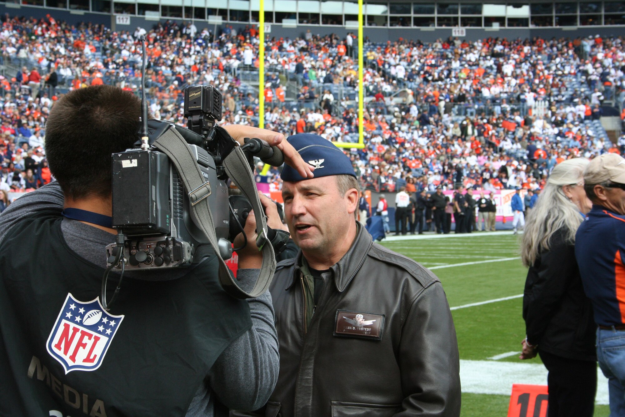 310th Space Wing vice commander Col. Mark D. Hustedt gives an interview to Colorado Springs Channel 13 about the employment opportunities at the 310th before the Denver Broncos game Oct. 4 in Denver, Colo. (U.S. Air Force photo/Capt. Maren P. Barney)