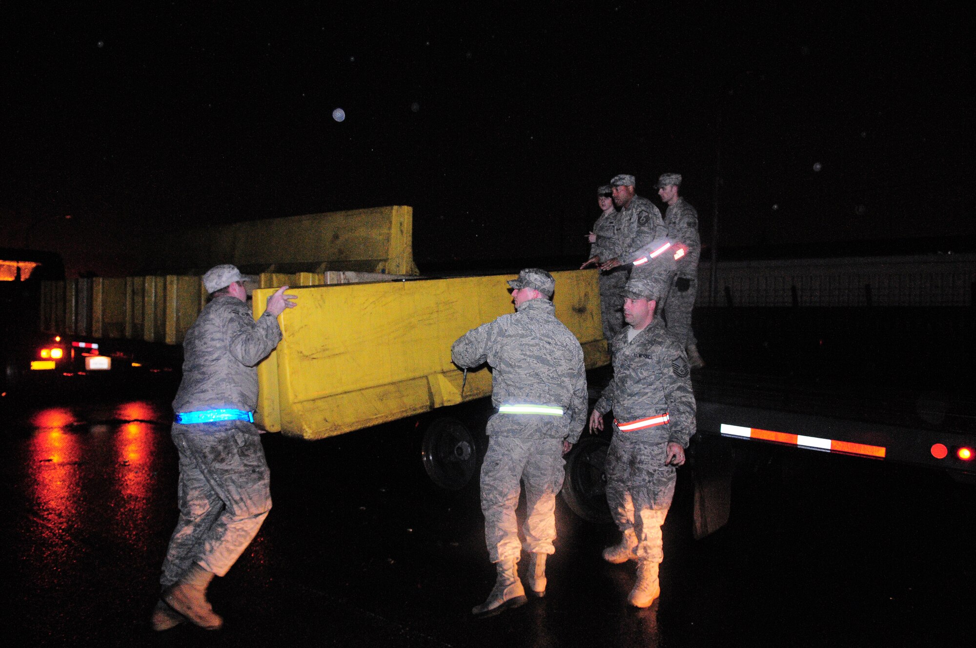 YOKOTA AIR BASE, Japan -- Airmen from the 374th Airlift Wing prepare portable barriers for installation throughout the base Oct. 5 in response to a simulated increase in force protection conditions during Beverly-Bearcat 09-05, an operational readiness inspection conducted by the Pacific Air Forces Inspector General. (U.S. Air Force photo/Airman 1st Class Michael Dillon)