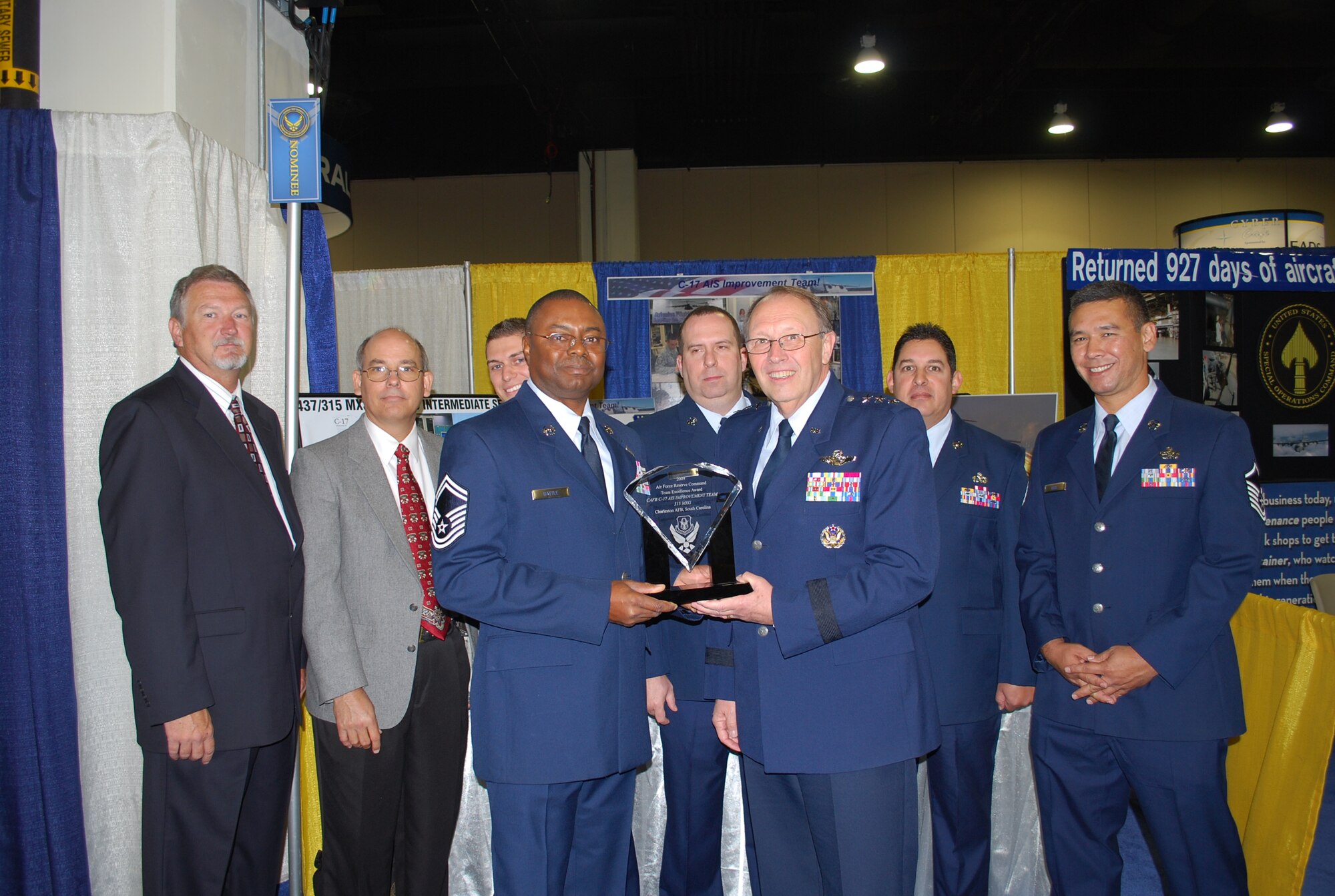 Lieutenant General Charles Stenner, commander of Air Force Reserve Command, presents the 2009 Air Force Reserve Command Team Excellence Award to Senior Master Sgt. Ken Battle, 315th Maintenance Squadron flight superintendent, and his team during the Air Force Association Air and Technology Expo in Washington, D.C. Sept. 15, 2009. The Avionics Section Improvement Team's hard work resulted in $24.2 million in savings for 2008, as well as an average component repair turn-around time of less than 20 hours, a 60 percent improvement over the command standard. (U.S. Air Force courtesy photo)