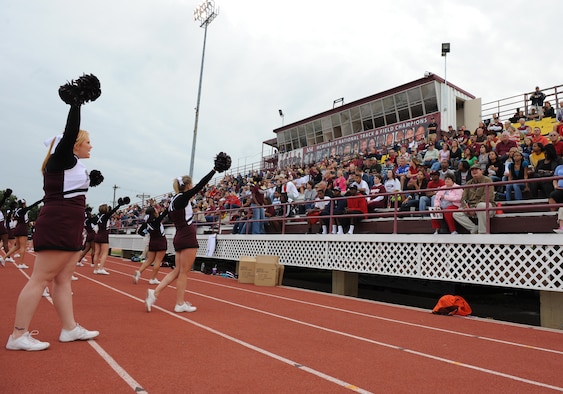 McMurry University cheerleaders lead the crowd in a cheer at Wilford Moore Stadium during Military Appreciation Day here, Oct. 3. Military members and their families were honored guest with free food, a tailgate party, free game entry to the McMurry University versus East Texas Baptist University football game. McMurry ended a 17 game losing streak and beat East Texas Baptist University for the first time since 1948. ( U.S. Air Force photo by Senior Airmen Jenifer H. Calhoun) 
