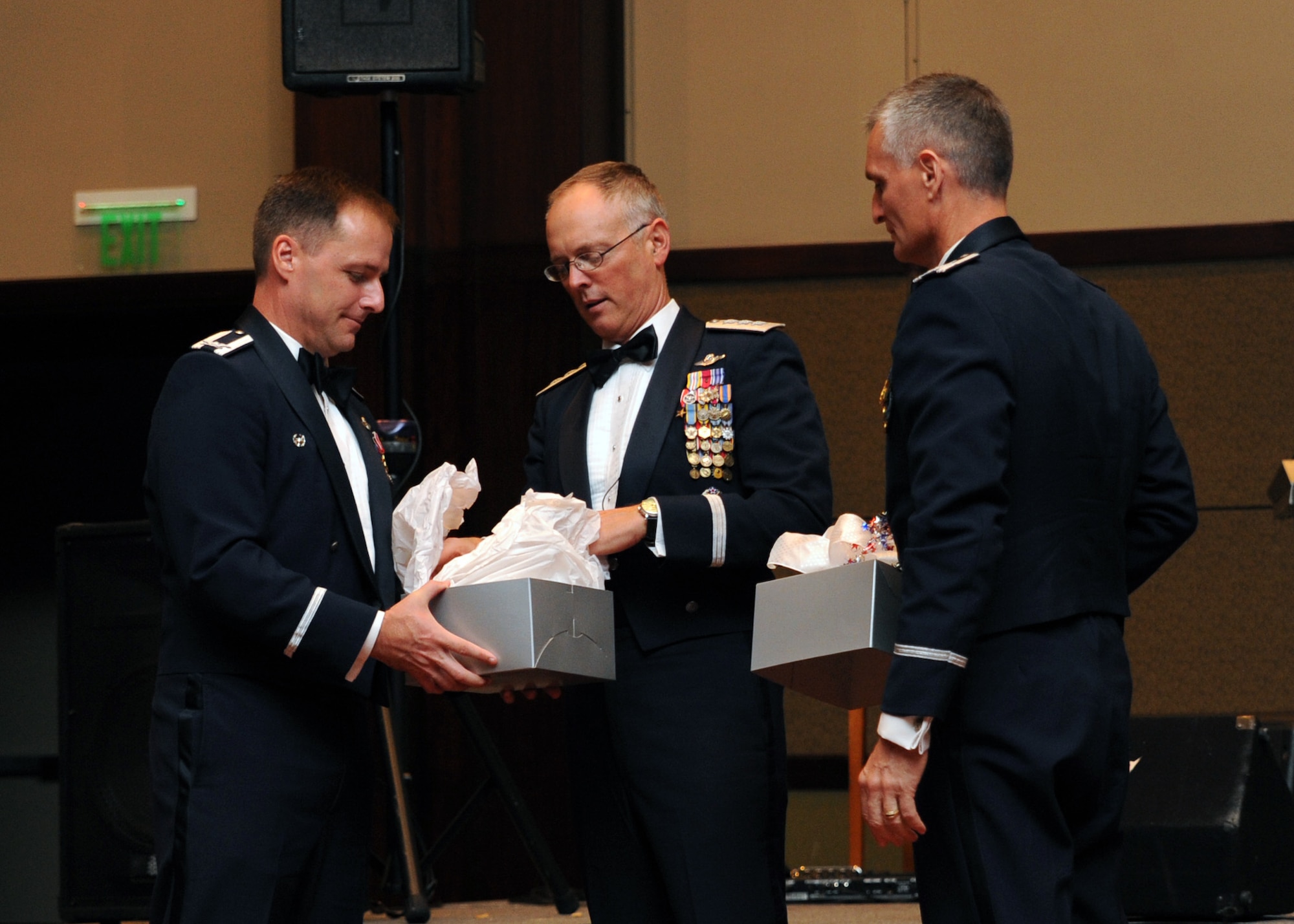 Col. John Wood and Col. Steve Chapman present Lt. Gen. Bob Allardice a gift at the Air Force Ball in the North Charleston Convention Center Oct. 3. More than 800 Airman and community leaders came together to celebrate the 62nd anniversary of the United States Air Force. Colonel Wood is the 437th Airlift Wing commander, Colonel Chapman is the 315th Airlift Wing commander and General Allardice is the 18th Air Force commander. (U.S. Air Force photo/Senior Airman Katie Gieratz)