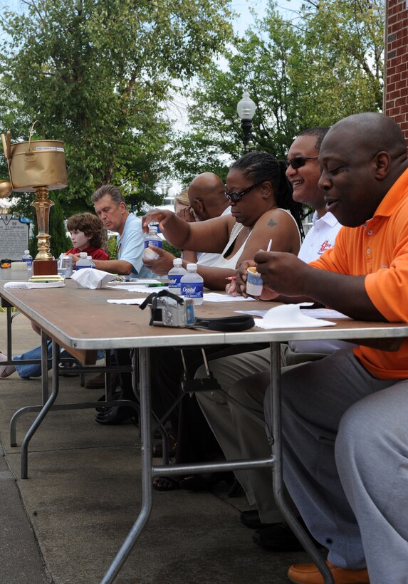 LANGLEY AIR FORCE BASE, Va. -- Judges taste chili in order to determine the best during the annual Hampton Division Fire and Rescue Chili Cook-off in downtown Hampton Oct. 3. The cook-off helped raise money for Hampton City fire prevention, which helps the community by installing free smoke detectors and raising awareness of fire prevention.  (U.S. Air Force photo/Senior Airman Zachary Wolf)

