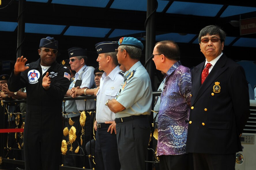Capt. Jason McCree, Thunderbird #12, explains manuevers to Malaysian government officials during the Thunderbird air show in Kuala Lumpur, Malaysia, Oct. 3. Also present was Lt. Gen. Hawk Carlisle, 13th Air Force commander, who attended for Gen. Gary North, Pacific Air Forces commander. The U.S. Air Force air demonstration squadron's tour of the Pacific aids in fostering friendships with U.S. allies, which helpt to promote security and stability throughout the region. (U.S. Air Force photo/Staff Sgt. Kristi Machado)