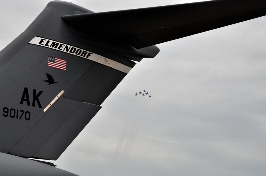 Thunderbirds fly in formation above a C-17 Globemaster III from Elmendorf Air Force Base, Alaska, during an air show in Kuala Lumpur, Malaysia, Oct. 3. The Elmendorf C-17 crew and another from Hickam AFB, Hawaii, are taked with getting the team to nine venues throughout the Pacific, including Australia, Thailand, Japan and South Korea. The Thunderbirds tour is designed to foster friendships with U.S. allies in the regioin, which helps promote security and stability throughout the Pacific. (U.S. Air Force photo/Maj. Vince Shrigley)