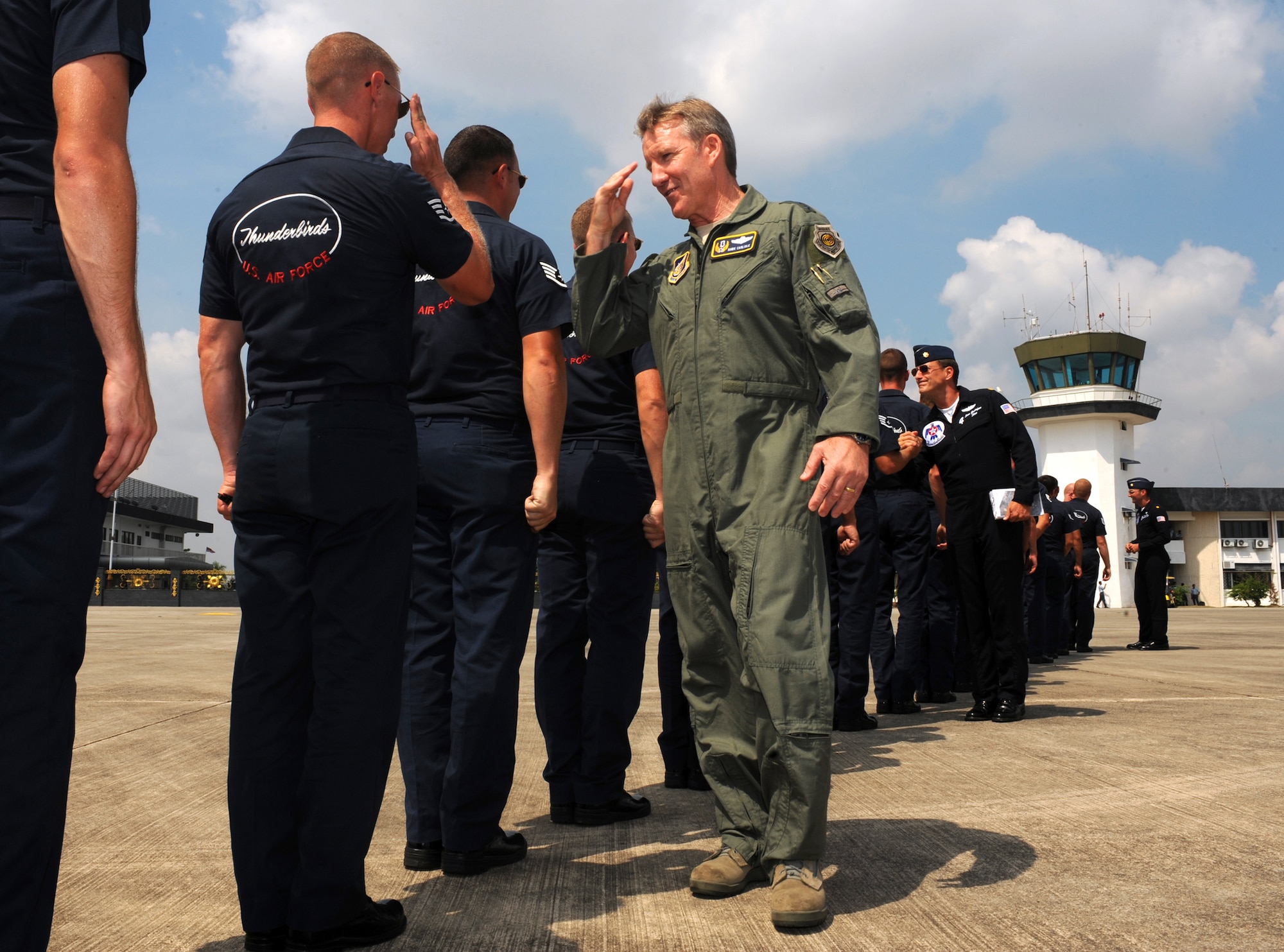 Lt. Gen. Hawk Carlisle, 13th Air Force commander, greets the Thunderbird maintenance team prior to his flight with the team Oct. 2 during an air show at Kuala Lumpur, Malaysia. The Thunderbirds' tour of the Pacific aids in fostering friendships with U.S. allies, which helps to promote security and stability in the region. (U.S. Air Force photo/Staff Sgt. Kristi Machado)