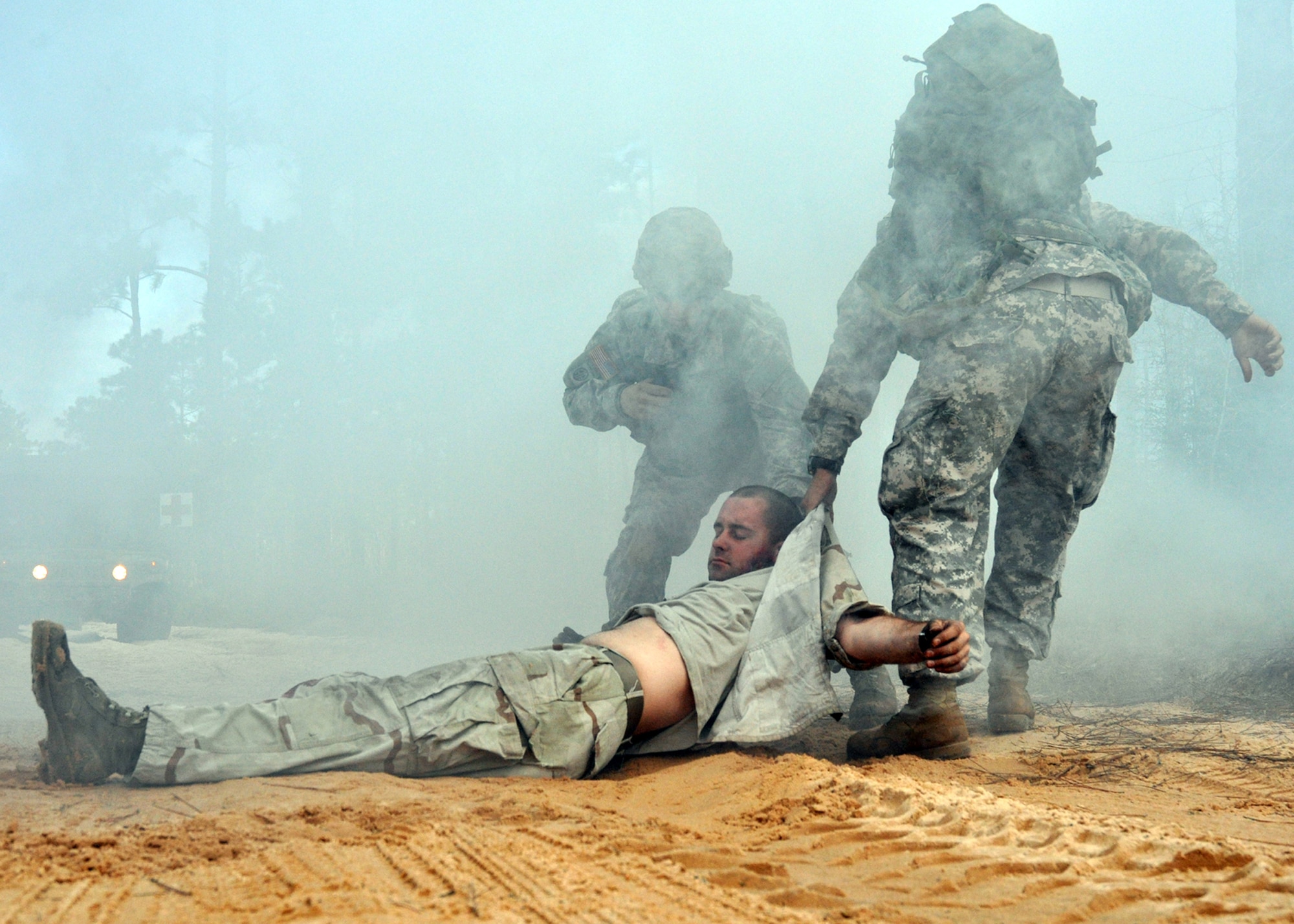 Sgt. Sean Lewis and Spc. Ian Jones, 6th Ranger Training Battalion medics, drag a simulated car accident victim away from the crash site to safety Oct. 1 during the 6th RTB's annual mass casualty exercise.  The exercise was to examine how effective the battalion responds as a group and how well it communicates and works with outside emergency agencies in the event of a catastrophe on Eglin's range.  (U.S. Air Force photo/Airman Anthony Jennings.)