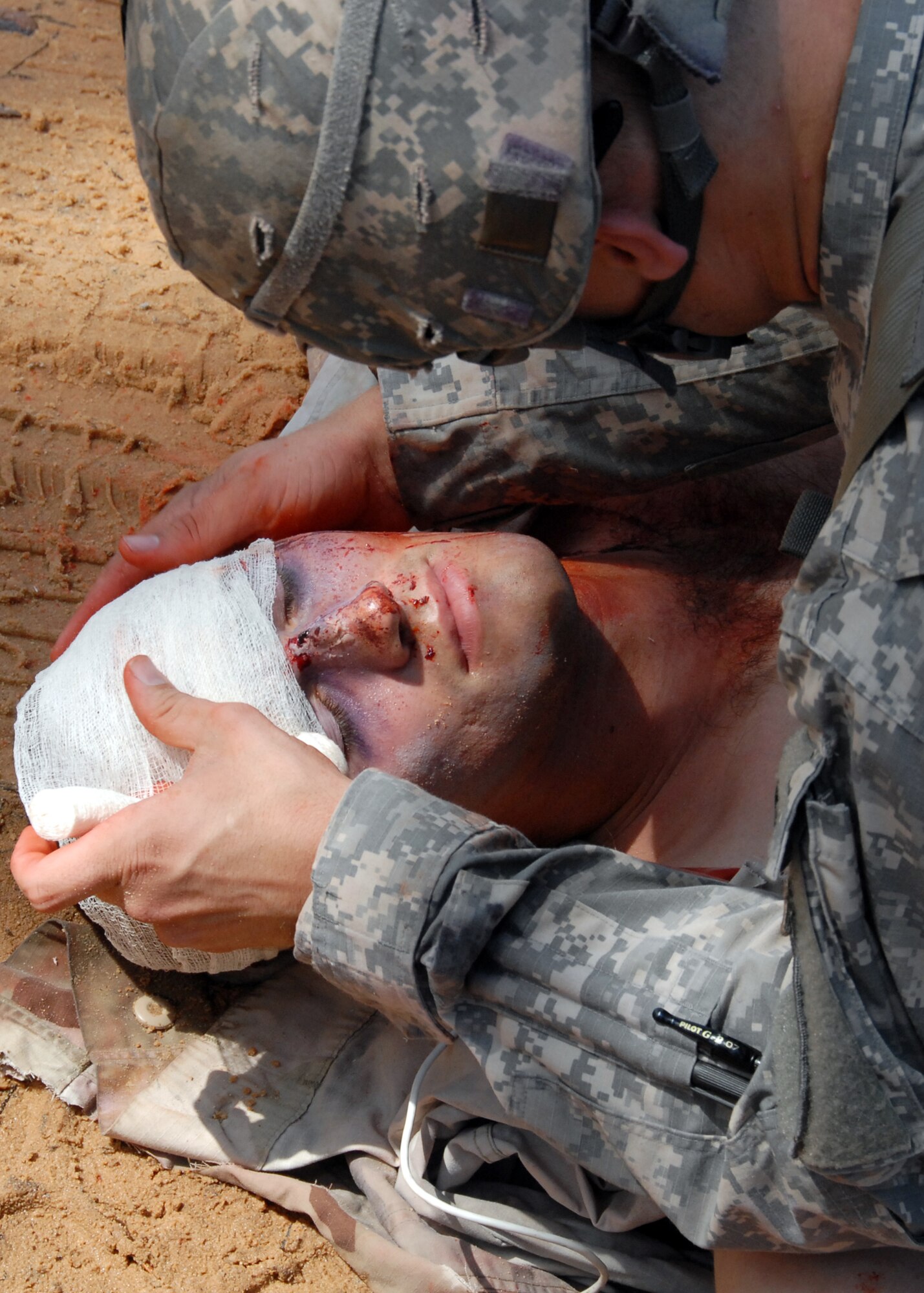 Sgt. Sean Lewis, 6th Ranger Training Battalion medic, bandages the head wound of a simulated car accident victim Oct. 1 during the 6th RTB's annual mass casualty exercise.  The exercise was to examine how effective the battalion responds as a group and how well it communicates and works with outside emergency agencies in the event of a catastrophe on Eglin's range.  (U.S. Air Force photo/Samuel King Jr.)