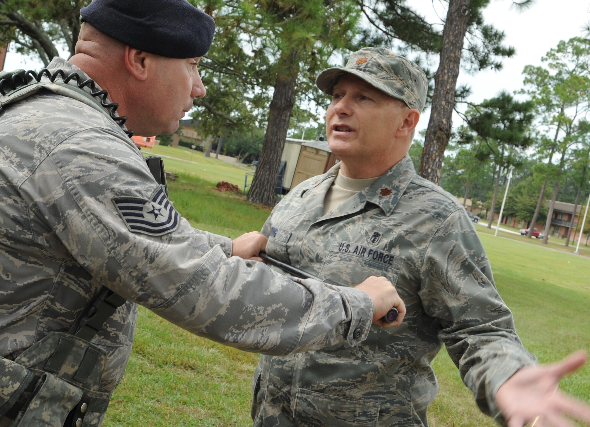 MOODY AIR FORCE BASE, Ga. -- Tech Sgt. Edwin Lipp, 23rd Security Forces Squadron NCO in-charge of confinement, attempts to subdue a disgruntled officer, Maj. Drew Widing, 23rd Medical Operations Squadron clinical medicine flight commander, during a pandemic point of dispense exercise here Oct. 2. The exercise was organized by the 23rd Medical Group to test Moody’s capability to conduct mass immunizations to base personnel. (U.S. Air Force photo by Staff Sgt. Elizabeth Rissmiller)