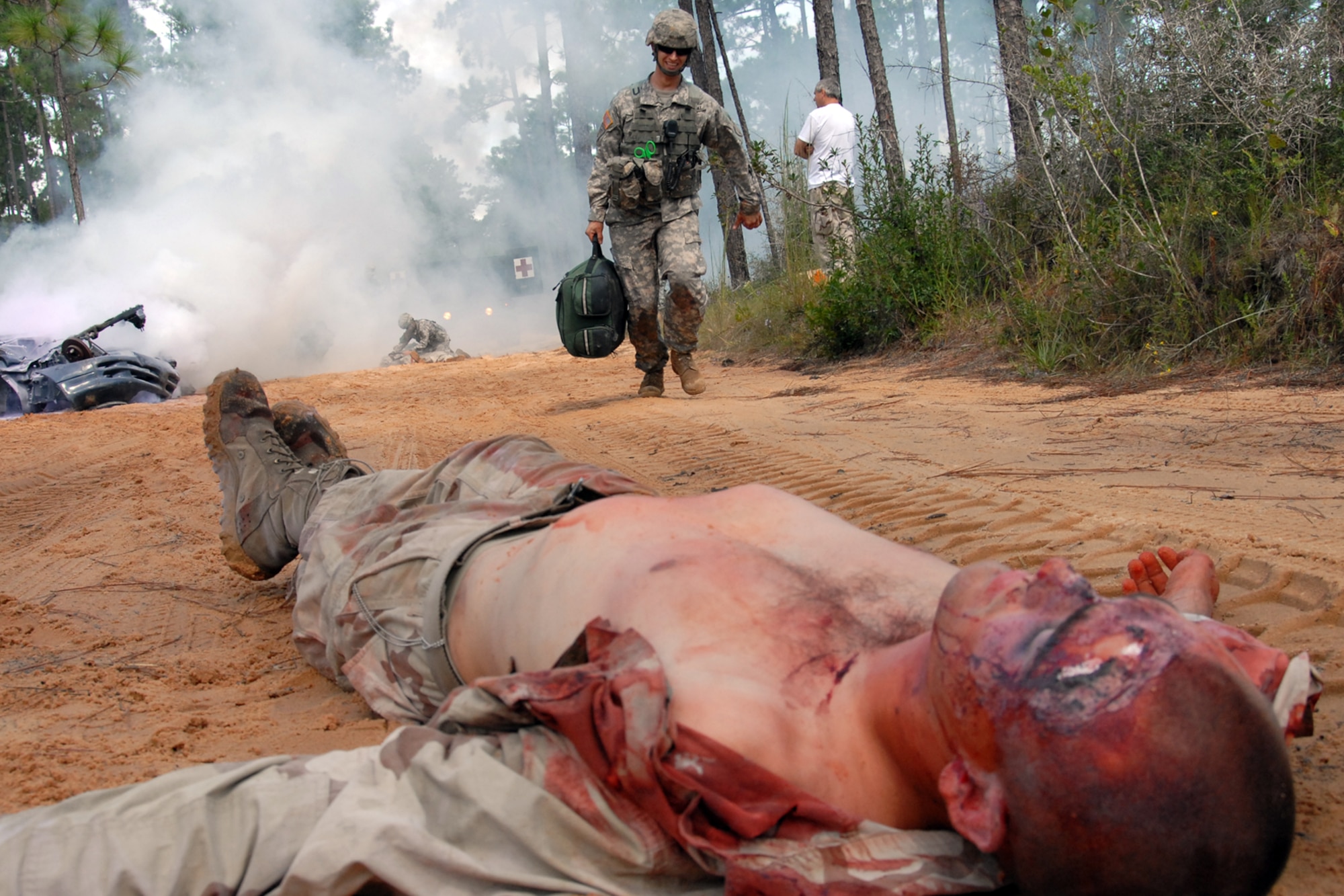 After checking on the first victim, Sgt. Sean Lewis, 6th Ranger Training Battalion medic, rushes past the wreckage to the next victim Oct. 1 during the 6th RTB’s annual mass casualty exercise.  The exercise was to examine how effective the battalion responds as a group and how well it communicates and works with outside emergency agencies in the event of a catastrophe on Eglin's range.  (U.S. Air Force photo/Samuel King Jr.)