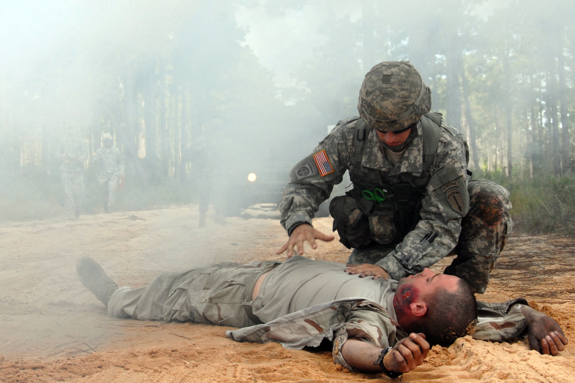 Sgt. Sean Lewis, 6th Ranger Training Battalion medic, looks for responses from a simulated car accident victim Oct. 1 during the 6th RTB's annual mass casualty exercise.  The exercise was to examine how effective the battalion responds as a group and how well it communicates and works with outside emergency agencies in the event of a catastrophe on Eglin's range.  (U.S. Air Force photo/Samuel King Jr.)