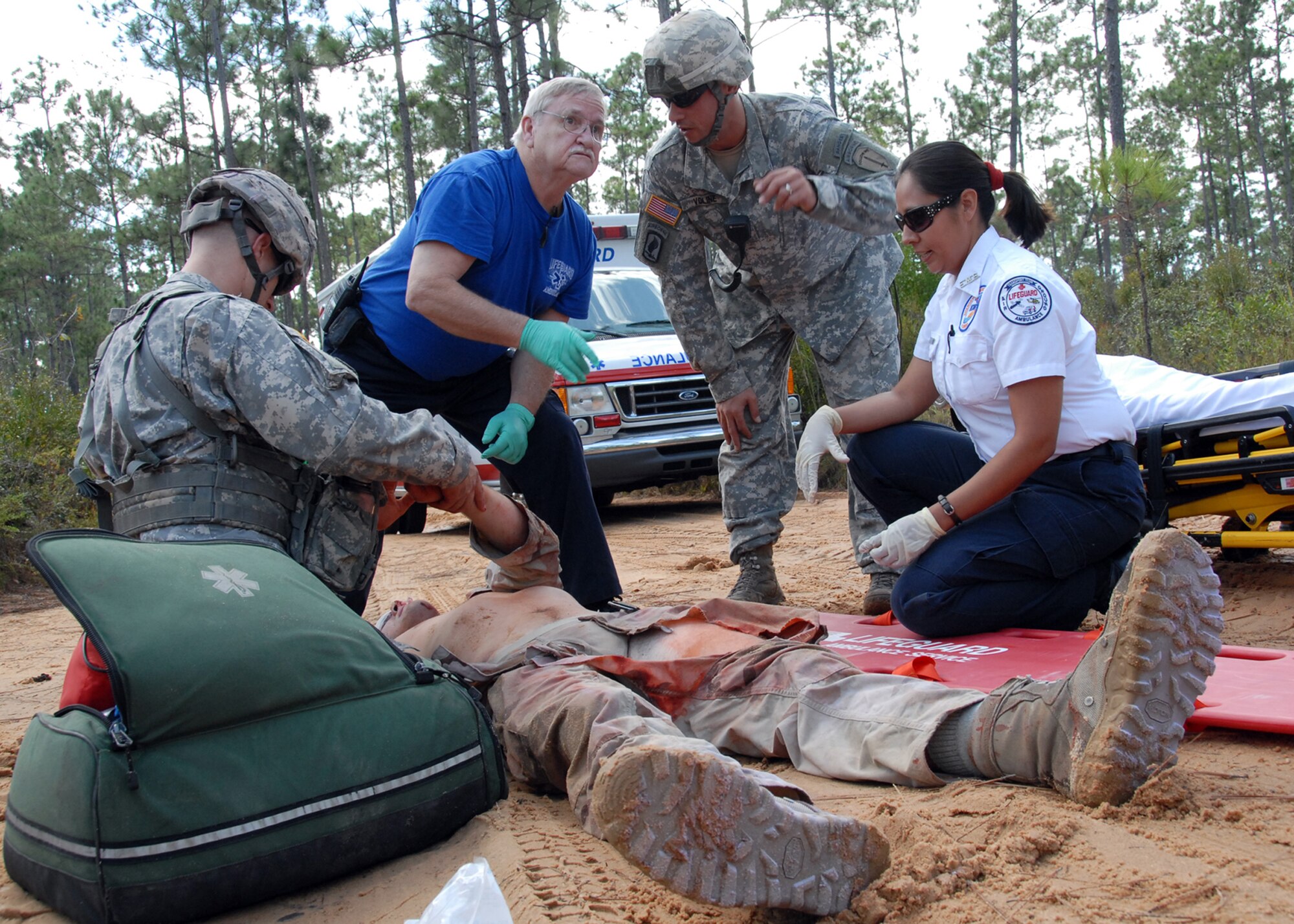 Local paramedics work with 6th Ranger Training Battalion Soldiers to assess the situation after a simulated car accident Oct. 1 during the 6th RTB’s annual mass casualty exercise.  The exercise was to examine how effective the battalion responds as a group and how well it communicates and works with outside emergency agencies in the event of a catastrophe on Eglin's range.  (U.S. Air Force photo/Samuel King Jr.)