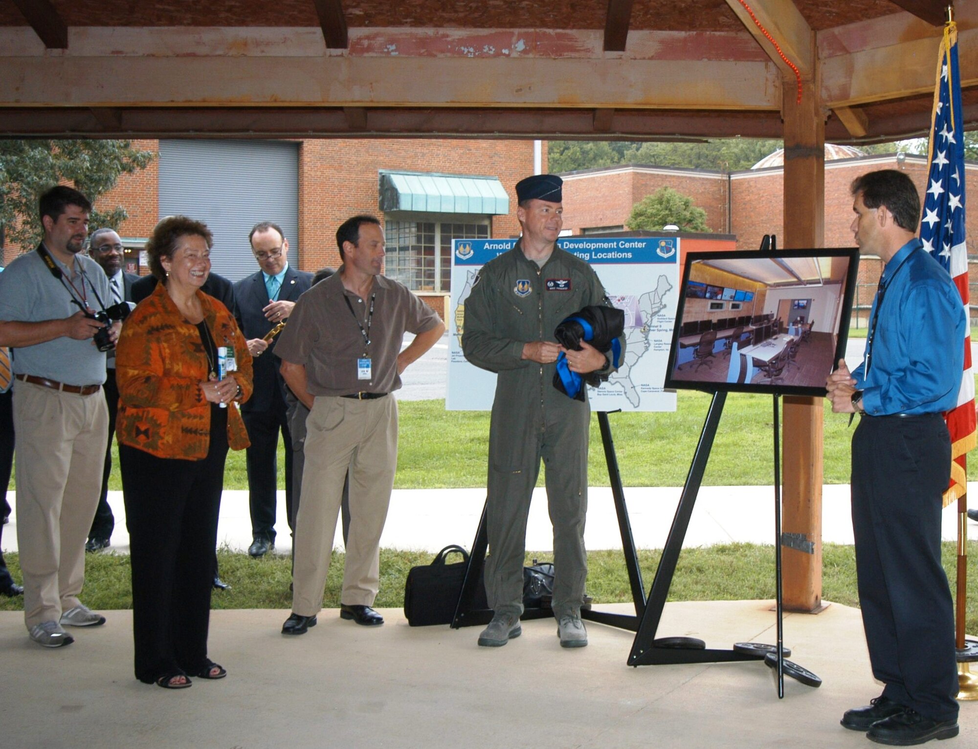 On Sept. 18, Arnold Engineering Development's (AEDC) White Oak Site Director Dan Marren (far right) and AEDC Commander Col. Michael Panarisi presided over a ribbon-cutting ceremony marking the completion of a major upgrade to the Hypervelocity Wind Tunnel 9's test control room. From left, Joseph Norris, Tunnel 9 project engineer, Betsy Betz, LabQuest chairperson, Steve Grant, lead controls engineer, took part in the ceremony, which was attended by approximately 100 guests. Marren said LabQuest, a partnership of local businesses, elected officials, economic development partners and residents have supported Tunnel 9 and its predecessor, the Naval Ordnance Lab, for years. (Photo provided)

