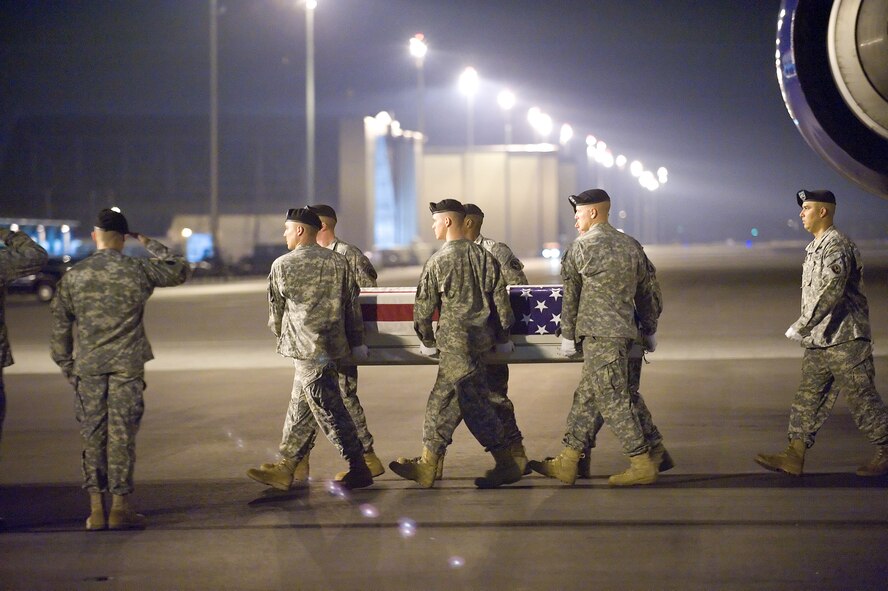 3 October 2009  USAF Photo by Jason Minto.  A U.S. Air Force and U.S. Army carry teams transfer the remains of Army Specialist Russell Hercules., of Murfreeburo, TN., at Dover Air Force Base, Del., October 3, 2009.  