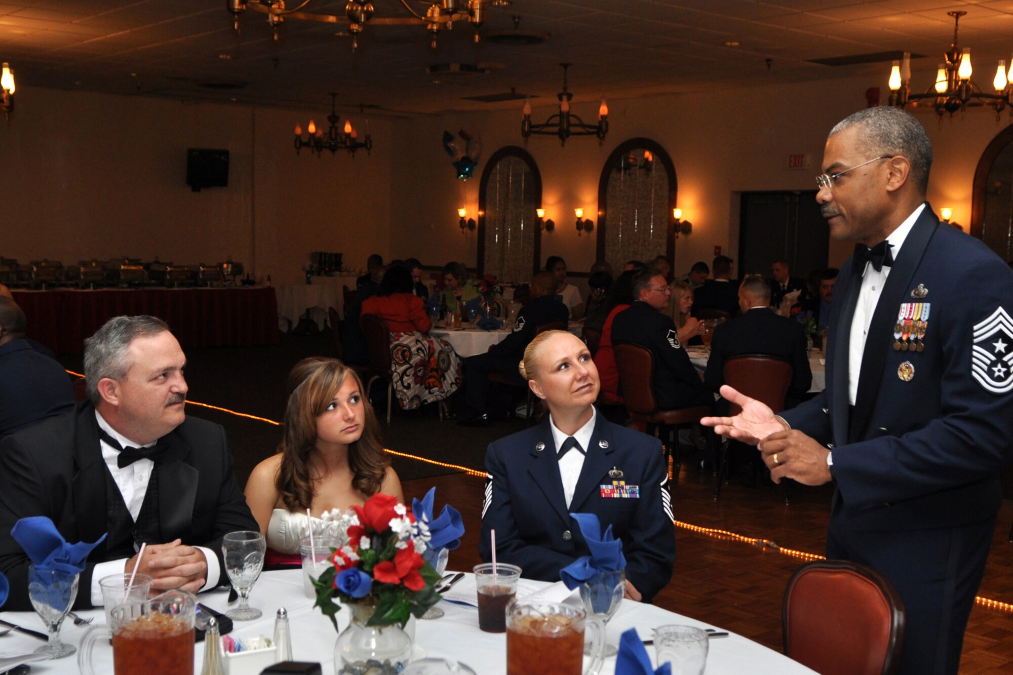 Chief Master Sgt. Jack Johnson, Jr., speaks with Master Sgt. Sheryl Donley, her husband Scott and daughter Kaitlin at the 917th Wing, 6th Annual, Senior Noncommissioned Officer Induction and Chief’s Recognition Ceremony at the Stripes Club on Barksdale Air Force Base, La., October 3, 2009. Chief Johnson, who is the Command Chief for the Air Force Global Strike Command at Barksdale, was the guest speaker for the ceremony. Master Sgt. Donley was inducted into the Senior NCO ranks as a Master Sergeant along with 30 other Airmen. A total of eight new Chiefs were also recognized during the evening’s events. (U.S. Air Force photo/Tech. Sgt. Jeff Walston)