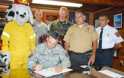 SOTO CANO AIR BASE, Honduras —  Col. Christopher Gehler, Joint Task Force-Bravo commander, signs the fire prevention proclamation at the JTF-Bravo headquarters building Oct. 5. Fire prevention week was established to remember the Great Chicago Fire on Oct. 9, 1871. The tragic fire killed more than 250 people, left 100,000 homeless, destroyed more than 17,400 structures and burned more than 2,000 acres. Every year during the week of Oct. 8 fire stations around the country reach out to the community to remind families of the importance of fire prevention (U.S. Air Force photo/Staff Sgt. Chad Thompson).