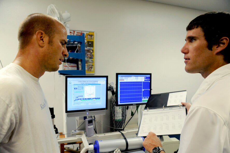 Capt. Dustin Benker reviews the results of his metabolic test with Dr. Jeff Nelson at the U.S. Air Force Academy's Human Performance Laboratory Sept. 29, 2009. The test measures oxygen consumption and carbon dioxide production and can provide athletes with specific training plans to enhance their physical performance. Captain Benker is a KC-135 Stratotanker pilot. Dr. Nelson holds a degree in exercise physiology. (U.S. Air Force photo/J. Rachel Spencer)