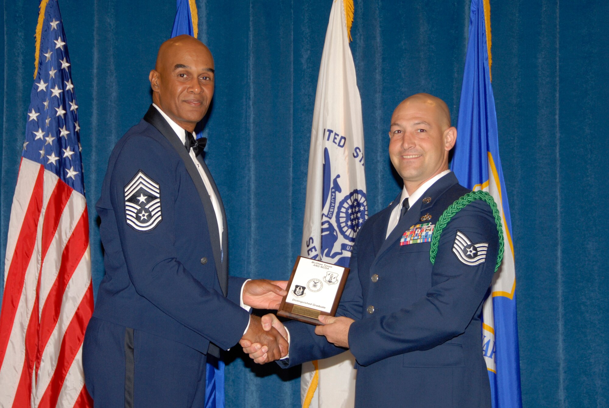 McGHEE TYSON AIR NATIONAL GUARD BASE, Tenn. -- Tech. Sgt. Tyler O. Weisgram, the unit deployment manager for the 49th Civil Engineer Squadron at Holloman AFB, N.M., receives the Distinguished Graduate Award for NCO Academy Class 09-6 at The Air National Guard Training and Education Center here from Chief Master Sgt. Leroy Frink, Sept. 30, 2009.  The Distinguished Graduate Award is presented to students in the top ten percent of the class.  It is based on objective and performance evaluations, demonstrated leadership, and performance as a team player.   (U.S. Air Force photo by Master Sgt. Kurt Skoglund)