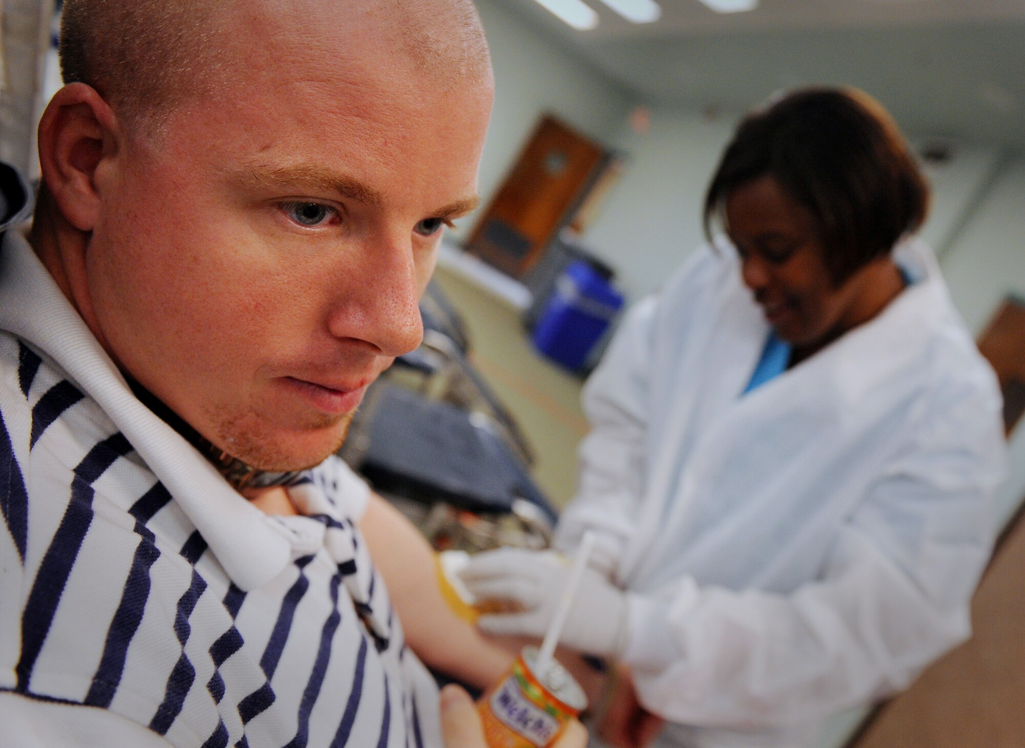MOODY AIR FORCE BASE, Ga. -- Jesse Webster, 23rd Civil Engineer Squadron environmental management system coordinator, looks away as Annie Jackson, American Red Cross collection technician II, removes a needle from his arm after donating blood during a blood drive here Oct. 2. (U.S. Air Force photo by Senior Airman Gina Chiaverotti-Paige)