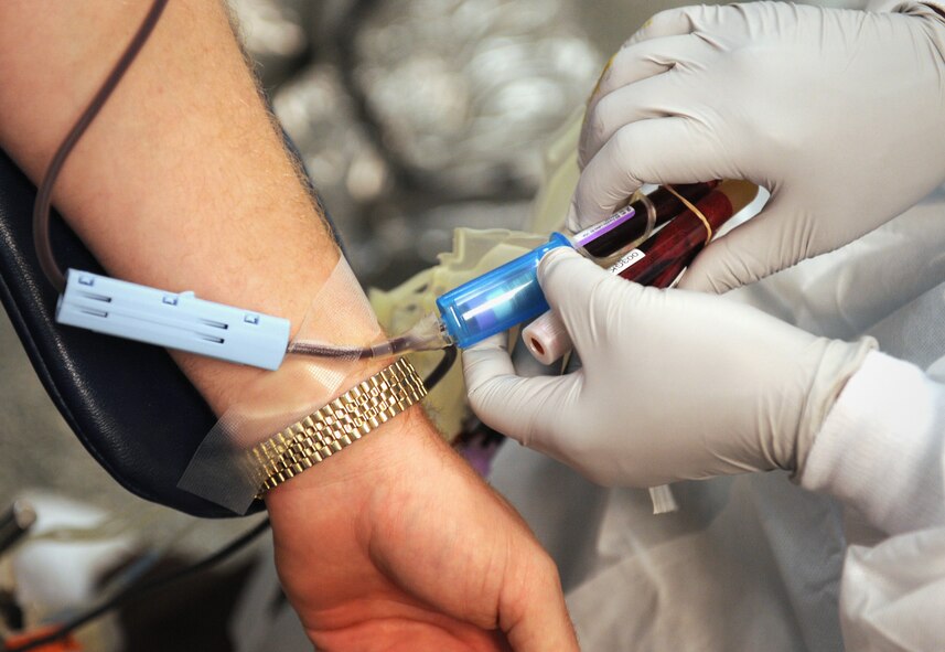 MOODY AIR FORCE BASE, Ga. -- Annie Jackson, American Red Cross collection technician II, finishes drawing blood from Jesse Webster, 23rd Civil Engineer Squadron environmental management system coordinator, who donates blood every 56 days, during a blood drive here Oct. 2. Individuals are authorized to donate blood every 56 days as long as they meet the age requirement of being at least 17 years old and are considered to be in good health. (U.S. Air Force photo by Senior Airman Gina Chiaverotti-Paige)