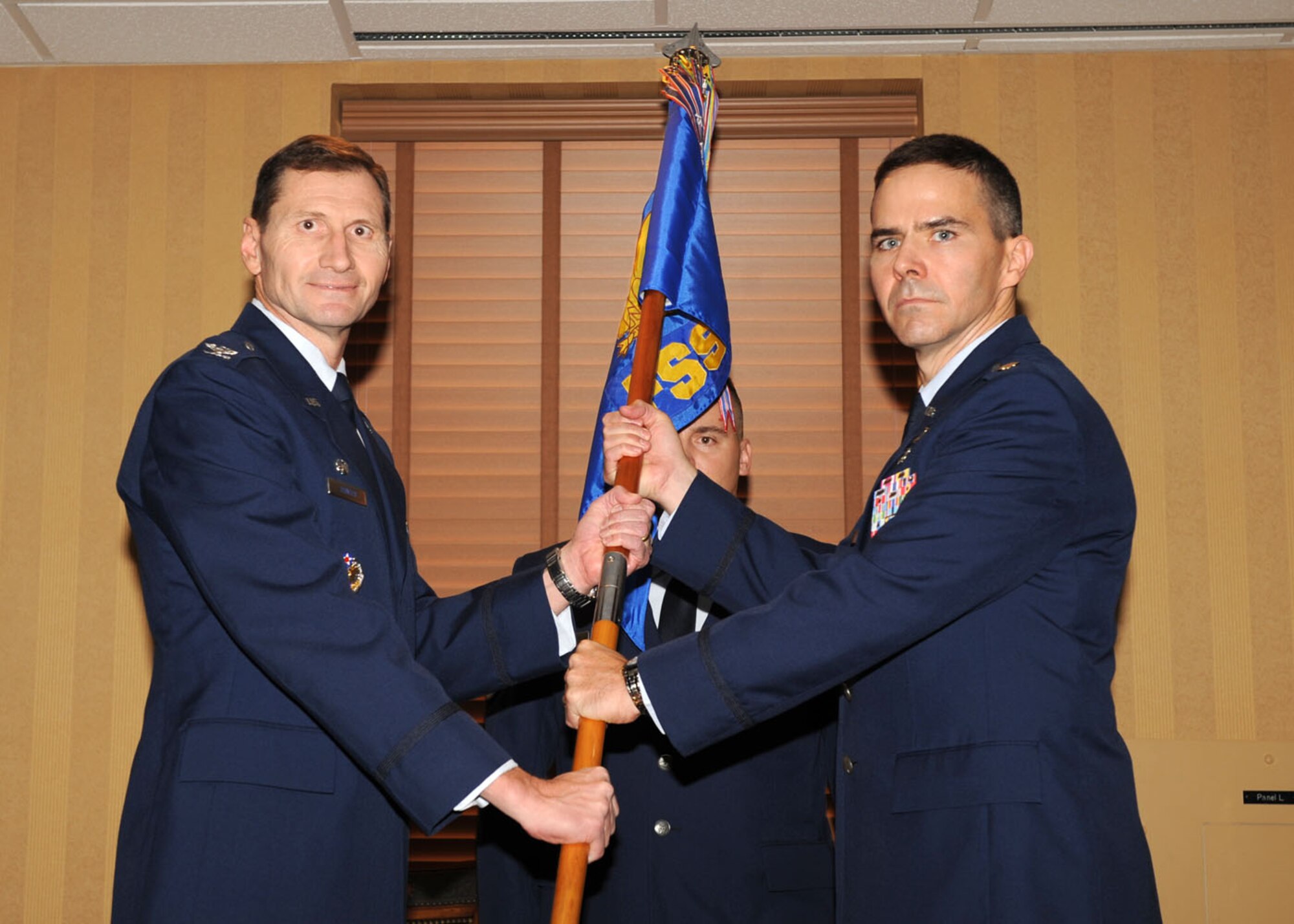 Maj. Ralph Taylor receives the 355th Force Support Squadron guidon from the
355th Mission Support Group Commander, Col. Charles Hunter, during a
change-of-command ceremony here Sept. 30. Major Taylor previously served as
the deputy commander of the 78th Force Support Squadron at Robins Air
Force Base, Ga. (U.S. Air Force photo/Airman 1st Class Brittany Dowdle)
