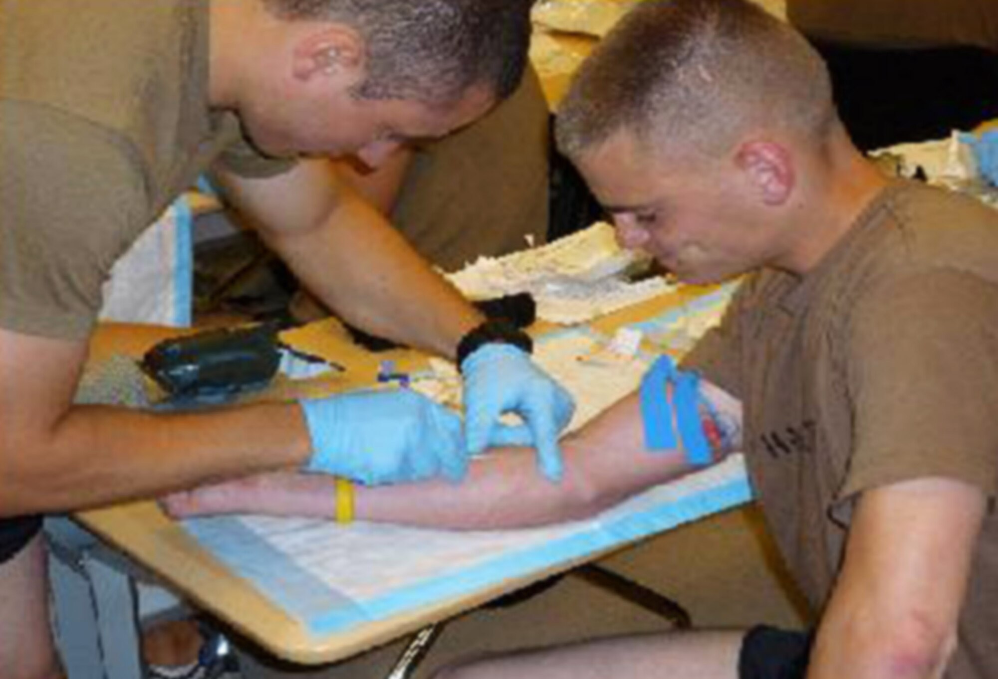 Norwich University ROTC Cadet Ian Kemp practices giving an IV to fellow Cadet Justin Hazlett as part of the special operations orientation program Sept. 23, 2009, at Hurlburt Field, Fla. During the program, cadets received classroom and hands-on instruction on how to perform and connect IVs. Cadets Kemp and Hazlett are assigned to Air Force ROTC Det. 867. (U.S. Air Force photo/Maj. Jeff Cooper) 