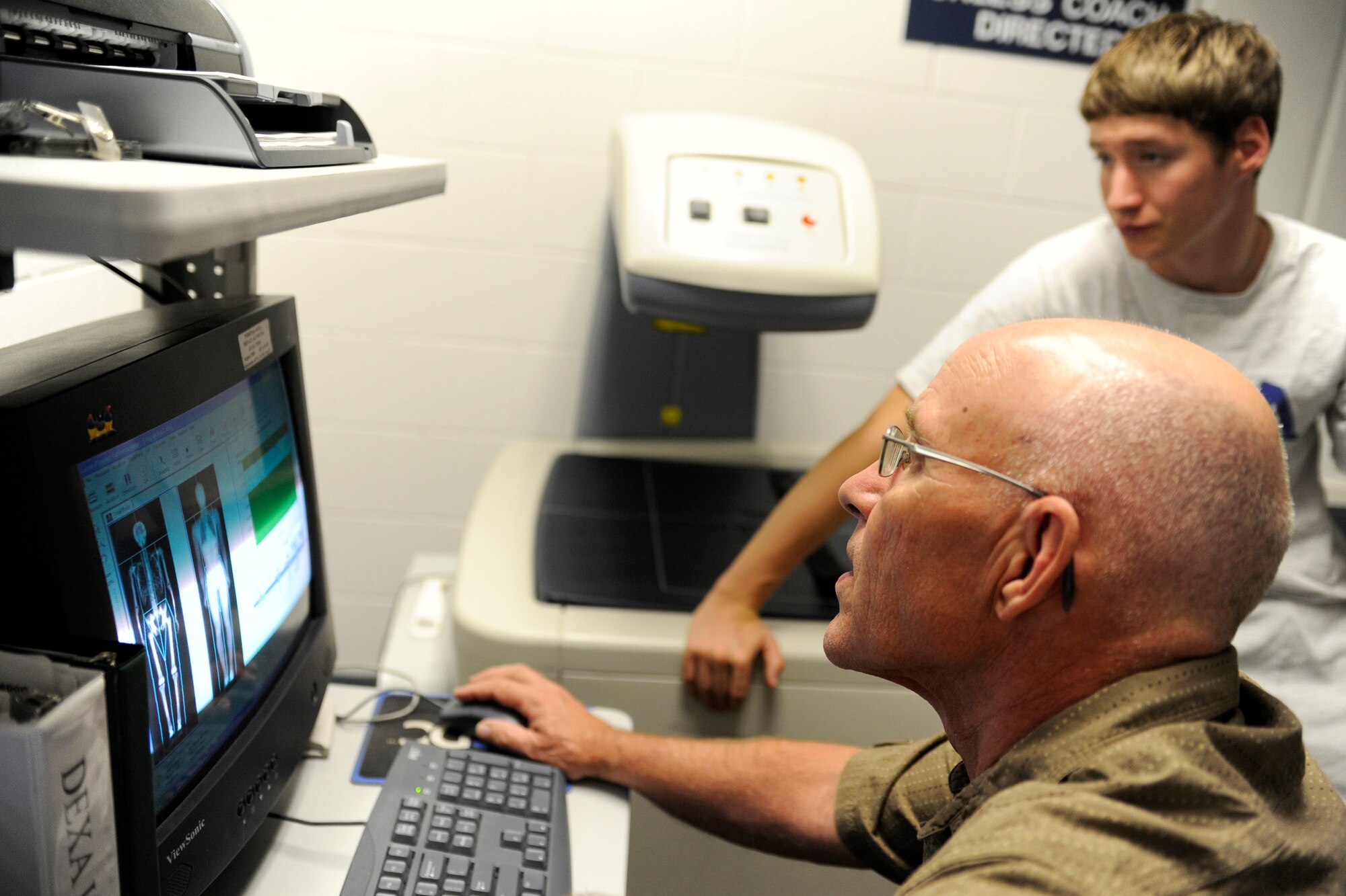 Cadet 3rd Class Jesse Bicknell, a member of the U.S. Air Force Academy Diving Team, goes over his Dual Energy X-ray Absorptiometry scan with intern Jim LaChapelle to get his percentage muscle to body fat and his bone density at the Academy's Human Performance Lab Sept. 28, 2009. Academy athletes take this scan about once a semester to track their progress. (U.S. Air Force photo/J. Rachel Spencer)