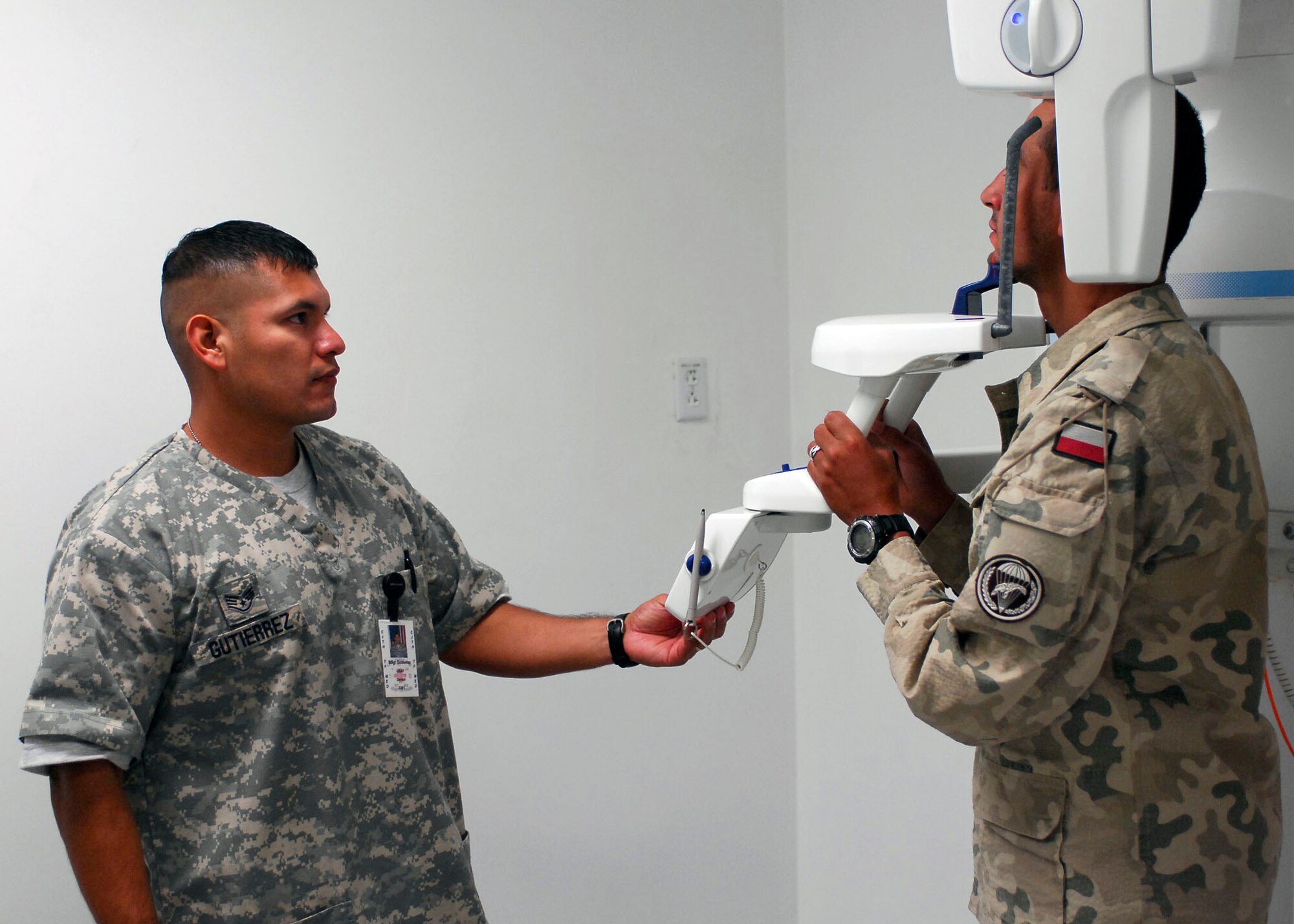 Staff Sgt. Juan Gutierrez, 12th Dental Squadron, positions a patient for a panoramic X-ray during his deployment to Bagram Airfield, Afghanistan. Sergeant Gutierrez is deployed to Afghanistan for six months, currently serving as the Dental Clinic NCOIC for Task Force Medical. (U.S. Air Force photo/Senior Airman Felicia Juenke)