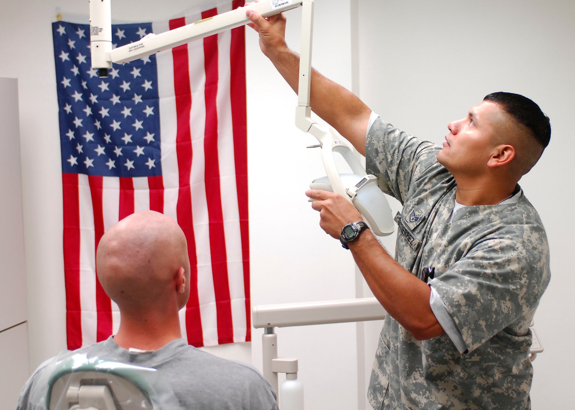 Staff Sgt. Juan Gutierrez, 12th Dental Squadron, sets up for a patient during his deployment to Bagram Airfield, Afghanistan. Sergeant Gutierrez is deployed to Afghanistan for six months, currently serving as the Dental Clinic NCOIC for Task Force Medical. (U.S. Air Force photo/Senior Airman Felicia Juenke)