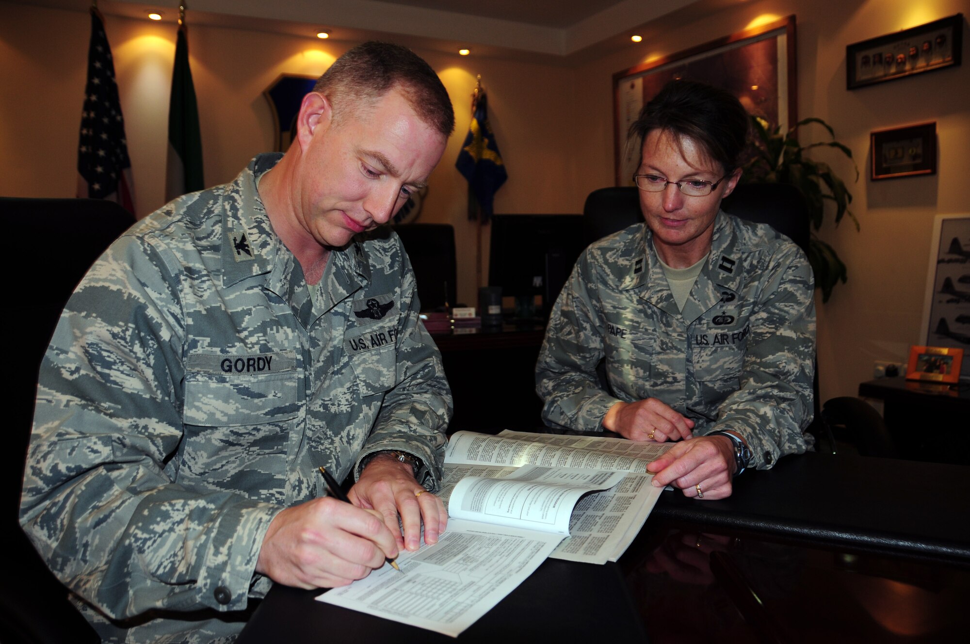 SOUTHWEST ASIA -- Col. John Gordy, 386th Air Expeditionary Wing commander, fills out his 2009 Department of Defense Combined Federal Campaign-Overseas form as Capt. Dana Pape, 386th AEW Sexual Assault Response Coordinator and 2009 CFC-O coordinator, looks on. The 2009 CFC is an opportunity for military members to contribute to various chairities. The campaign runs through Nov. 15. (U.S. Air Force photo/Staff Sgt. Shaun Emery) 