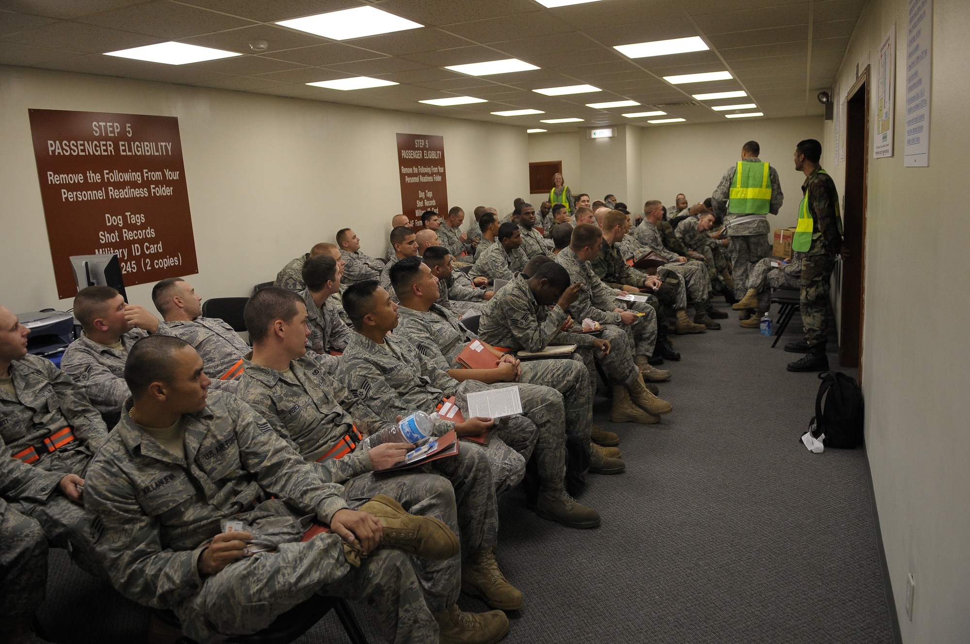 YOKOTA AIR BASE, Japan -- Airmen from the 374th Airlift Wing wait to simulate the deployment process during Beverly-Bearcat 09-05, an operational readiness inspection conducte by the Pacific Air Forces Inspector General. (U.S. Air Force photo/Airman 1st Class Michael Dillon)