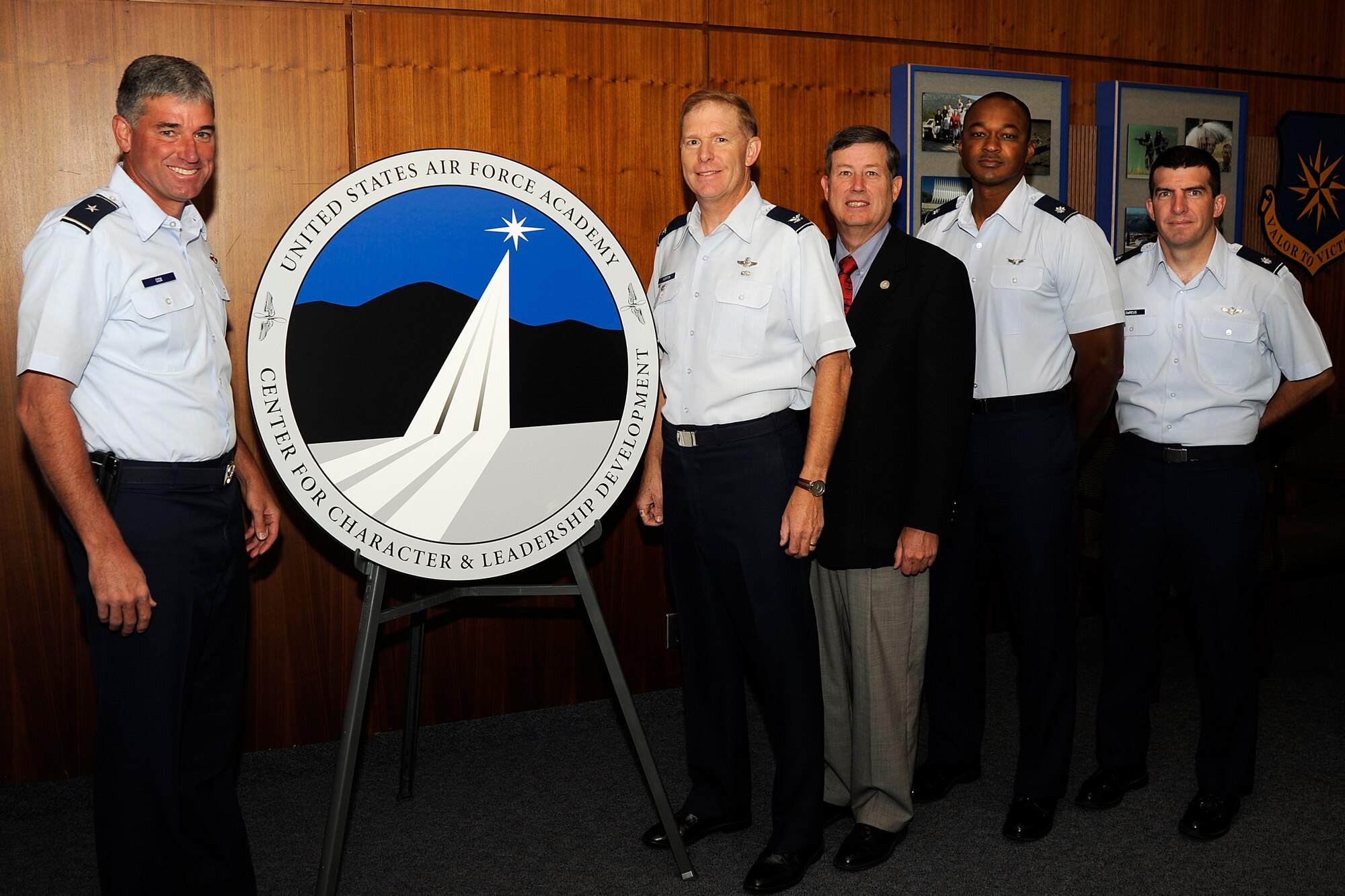 Brig. Gen. Samuel Cox and Col. John Norton unveil the Center for Character and Leadership Development's logo Sept. 28, 2009, at the U.S. Air Force Academy in Colorado Springs, Colo. General Cox is commandant of cadets at the Academy, and Colonel Norton is the CCLD director. Also pictured are retired Col. Tom Berry, deputy CCLD director; Lt. Col. Joe Sanders, assistant director for scholarship, and Lt. Col. Jim DeReus, assistant director for integration. The logo was designed by Chris Hureau of DenMar Services Inc. (U.S. Air Force photo/Rachel Boettcher)