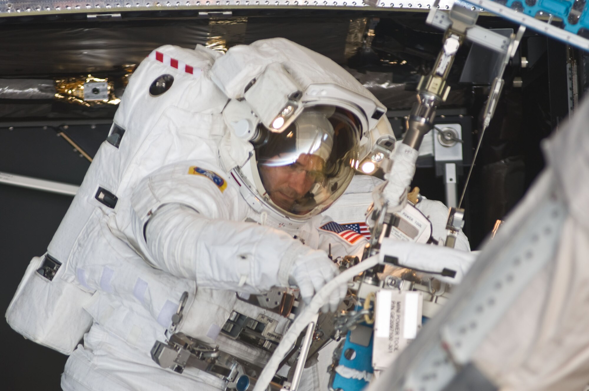 Col. Michael Good, an astronaut on mission STS-125, participates in the mission’s fourth session of extravehicular activity May 17, 2009, as work continues to refurbish and upgrade the Hubble Space Telescope. During the eight-hour, two-minute spacewalk, Colonel Good continued repairs and improvements to the Space Telescope Imaging Spectrograph that will extend the Hubble’s life into the next decade. (Courtesy photo)