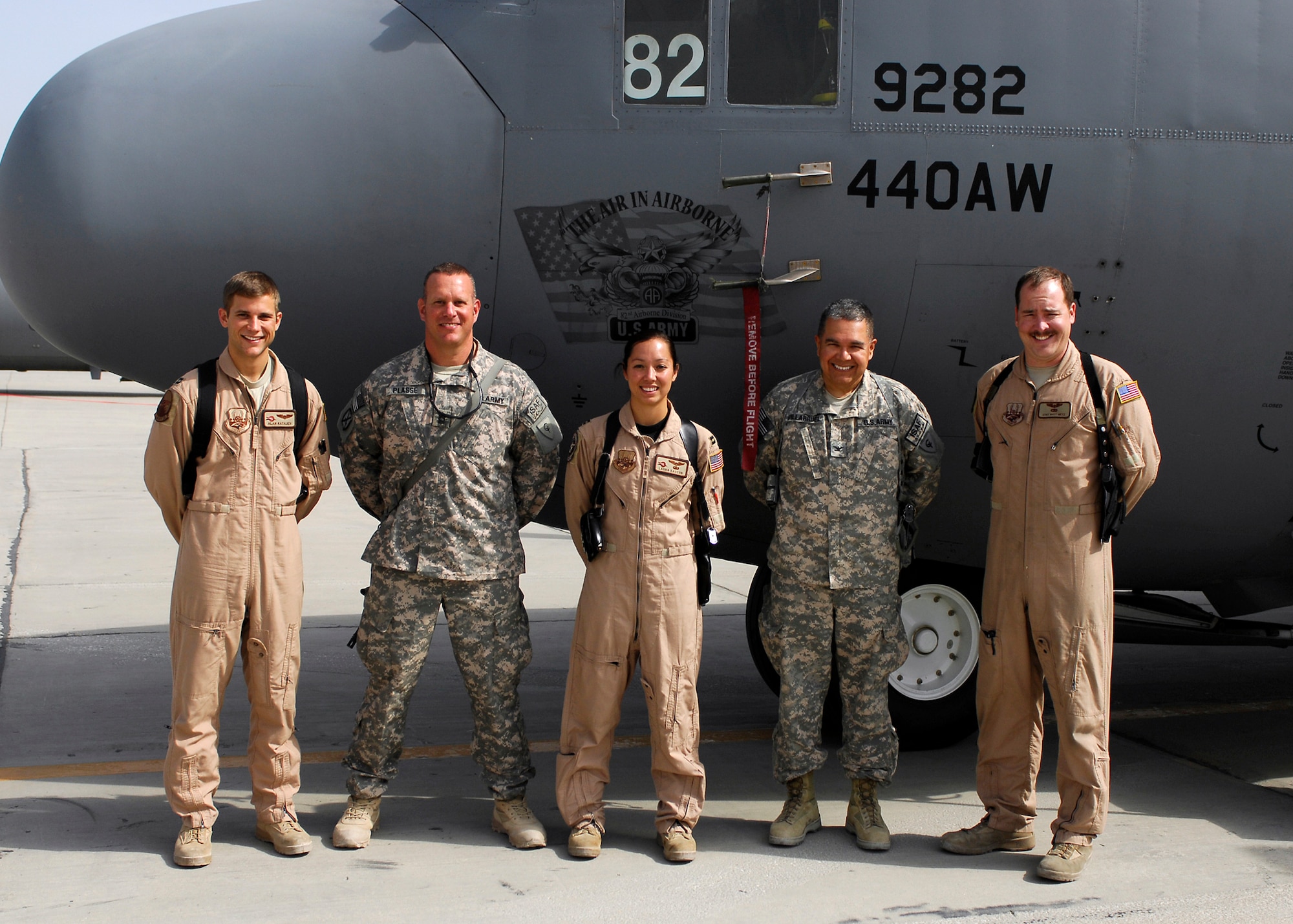 BAGRAM AIRFIELD, Afghanistan -- (Left to Right) Captain Alan Rothjen, Army Master Sgt. John Passe, Capt. Laura Easton, Army Col. Luis Villarruel, and Staff Sgt. Matt Metz stand in front of the 82nd Airborne Division nose art on a C-130 Hercules here, Oct. 5, 2009. The C-130 was dedicated to the 82nd in honor of the cohesion of the Air Force and the Army in Afghanistan and was put on display for servicemembers to view the aircraft.  Captain Rothjen, Capt. Easton and Staff Sgt. Metz are deployed from the 43rd Airlift Wing at Pope Air Force Base, N.C.  Captain Rothjen, a C-130 pilot, hails from St. Louis, Mo.  Master Sgt. Passe, an afghan national security forces liaison, is deployed from the Indiana Army National Guard's 38th Infantry Division, and hails from Terre Haute, Ind.  Captain Easton, a C-130 pilot, hails from Pittsburgh, Pa.  Colonel Villarruel, Task Force Cyclone's Surgeon, is deployed from the Army National Guard's 30th Infantry Division, and hails from Indianapolis, Ind.  Staff Sgt. Metz, a loadmaster, hails from Springfield, Va.  (U.S. Air Force photo/Senior Airman Felicia Juenke)