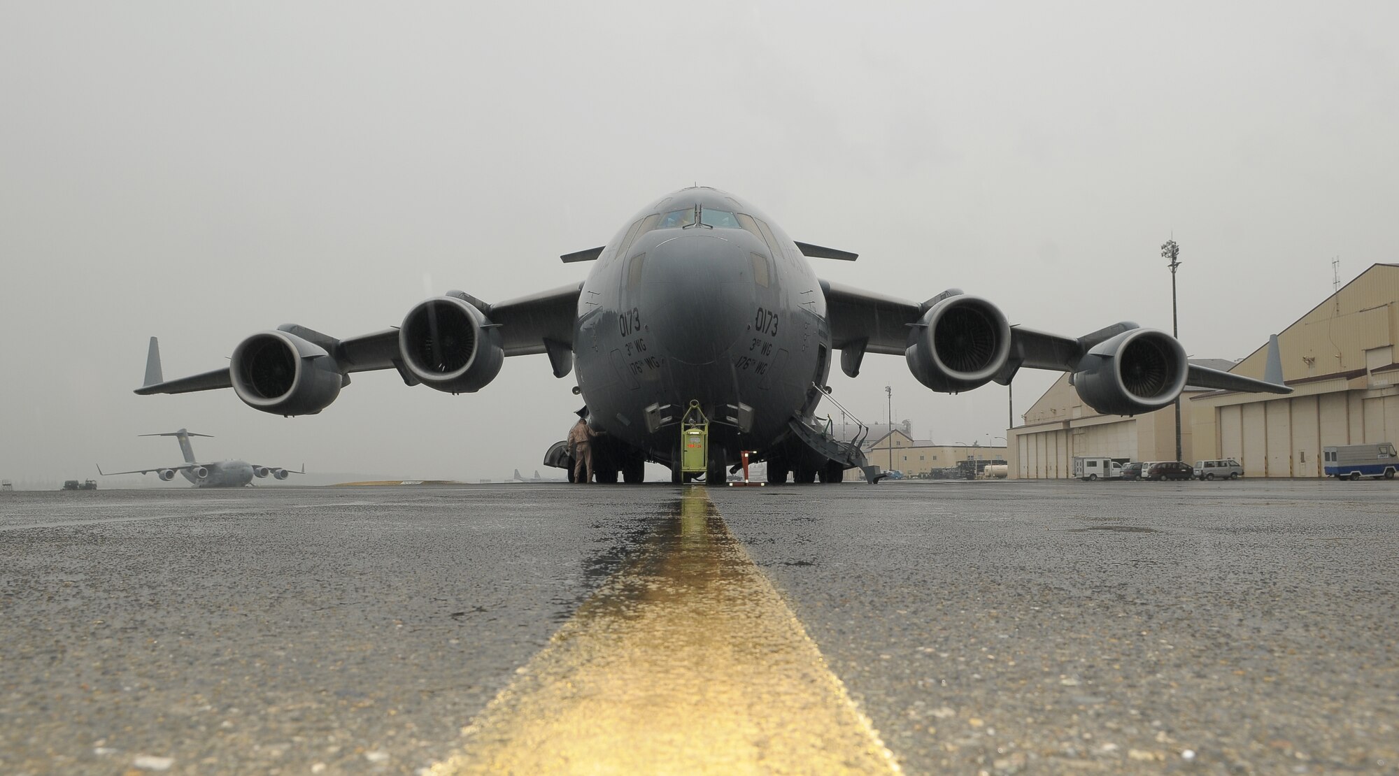 YOKOTA AIR BASE, Japan -- A C-17 Globemaster III from Elmendorf Air Force Base, Alaska, waits to take off Oct. 5 on a mission to transport 26 members of an Air Force Humanitarian Assistance Rapid Response Team and a seven-person mobile field surgical team en route to Padang, Indonesia, to provide medical care to those affected by the recent 7.6-magnitude earthquake. The crew from Elmendorf transported the team and the equipment necessary to support the team, which is self-sustaining for up to five days. (U.S. Air Force photo/Airman 1st Class Sean Martin)