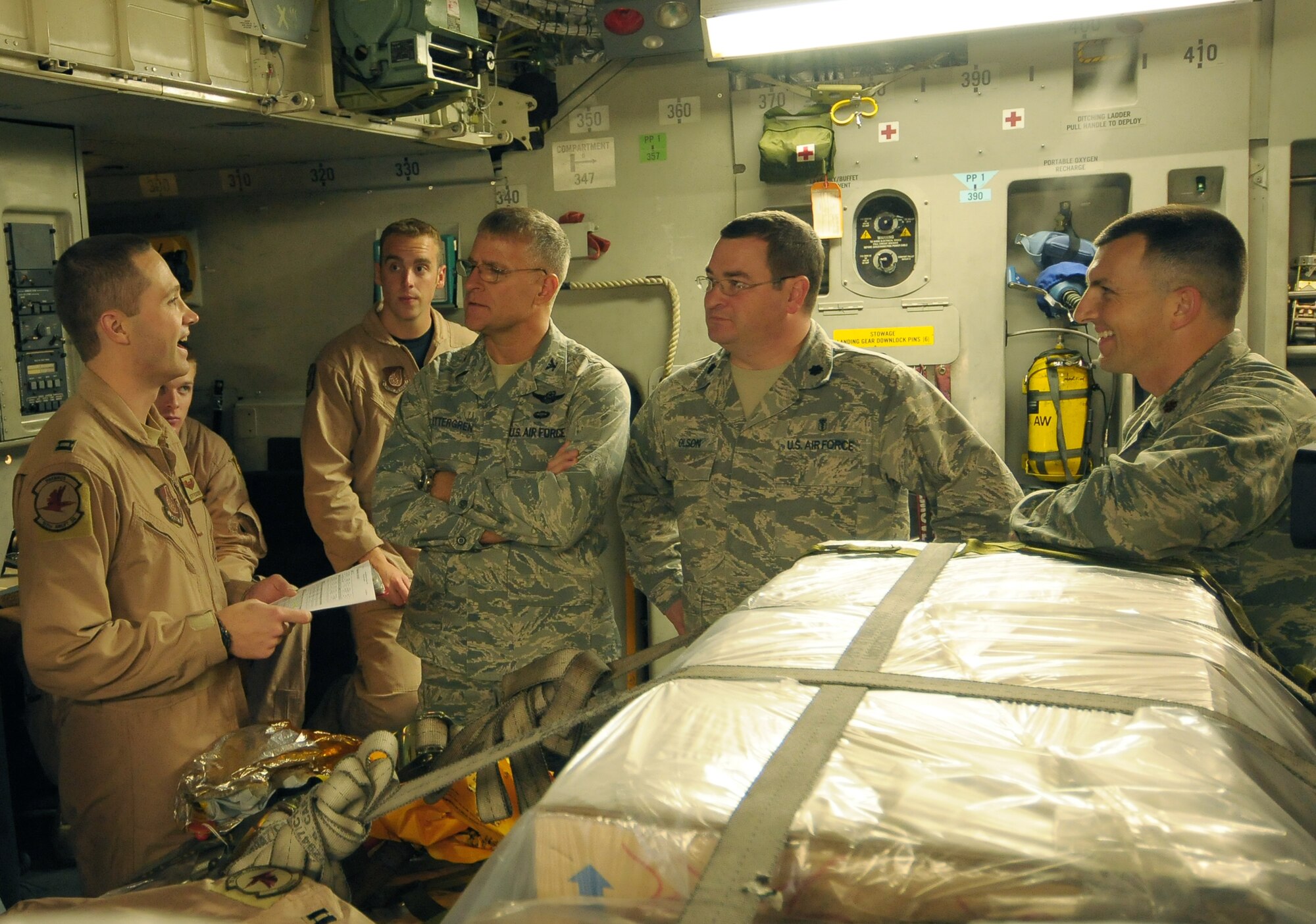 YOKOTA AIR BASE, Japan -- Capt. Jeff Pedersen, a C-17 aircraft commander from Elmendorf Air Force Base, Alaska, (left) briefs the leadership of an Air Force Humanitarian Assistance Rapid Response Team and a seven-person mobile field surgical team here Oct. 5 before the team's departure en route to Padang, Indonesia, to provide medical care to those affected by the recent 7.6-magnitude earthquake. The C-17  crew transported the team and 13 pallets of equipment necessary to support the team, which is self-sustaining for up to five days. (U.S. Air Force photo/Airman 1st Class Sean Martin)
