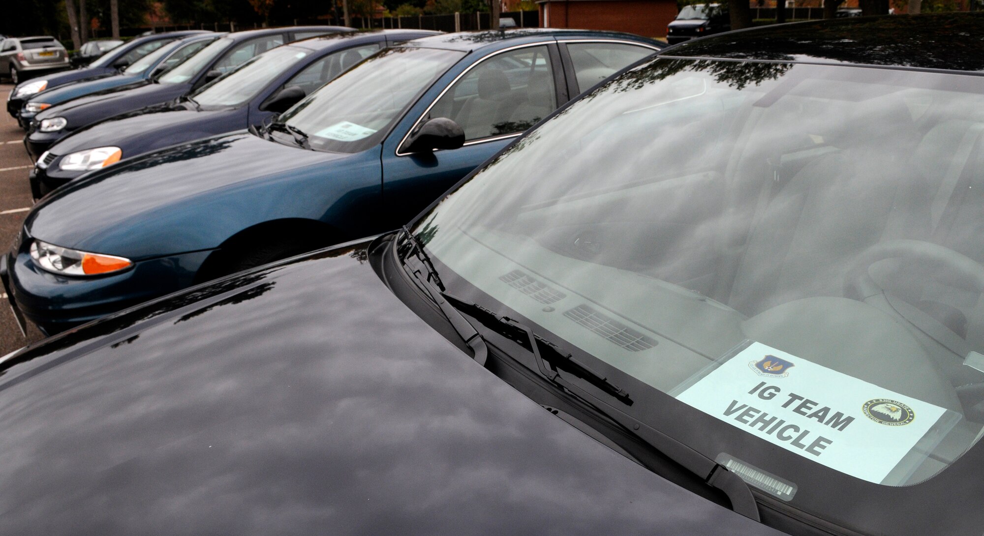 RAF MILDENHALL, England -- Government vehicles with inspector general team signs are parked by the 100th Air Refueling Wing Headquarters for use by inspectors during the Operational Readiness Inspection which began Oct. 5.  This highly-anticipated test reflects on the whole base and is the culmination of months of preparation.  (U.S. Air Force photo/Staff Sgt. Christopher L. Ingersoll)