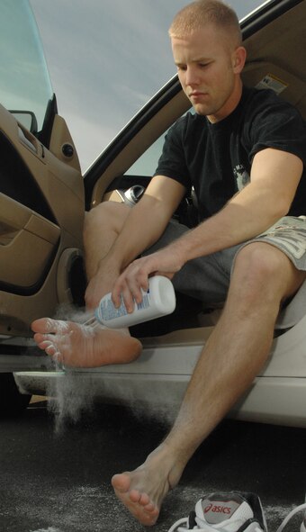 SPANGDAHLEM AIR BASE, Germany – Senior Airman Calvin Woody, 52nd Aircraft Maintenance Squadron, powders his feet during a 24 hour run/walk to raise money for Operation Warmheart here Oct. 2. Airman Woody participated in the event all 24 hours completing 56.5 miles. He received a trophy for going the most distance of any individual and raised more than $800. People participating in the run raised money through pledges for Operation Warmheart, which benefits Spangdahlem Airmen in times of financial need. (U.S. Air Force photo/Senior Airman Benjamin Wilson)