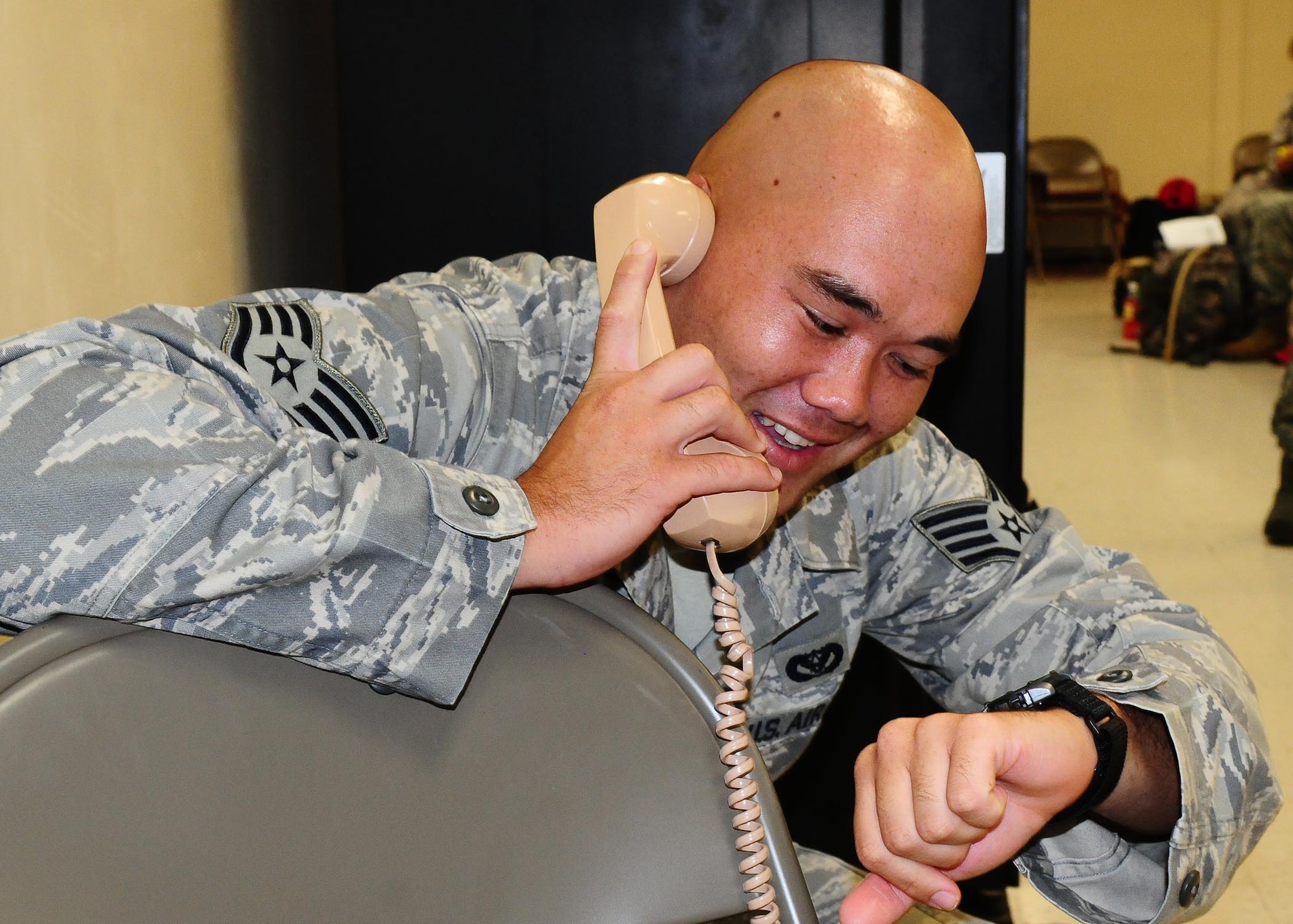 ANDERSEN AIR FORCE BASE, Guam-- Staff Sgt. Thomas Agee, 554th RED HORSE Squadron structural journeyman, calls home from the mobility deployment processing center here Oct. 5 before departing to Indonesia to assist in providing aid to victims after a 7.6 magnitude earthquake struck West Sumatra province on Sept. 30.  Sergeant Agee is part of a Humanitarian Assistance Rapid Response Team (HARRT), which is made up of members from the 36th Contingency Response Group and the 36th Medical Group at Andersen AFB.   (U.S. Air Force photo by Senior Airman Nichelle Anderson/Released)  